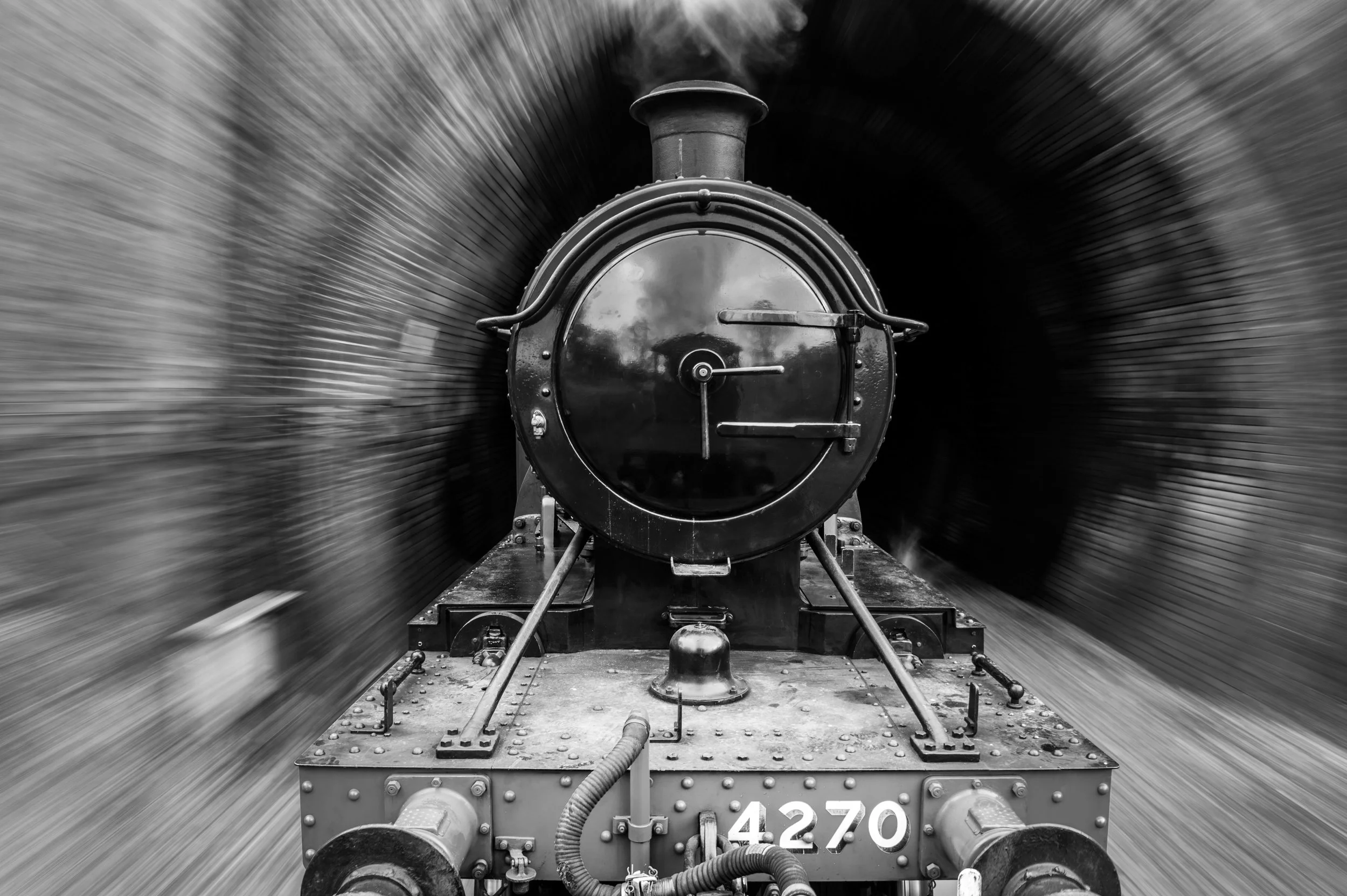 Black and white photo of a vintage steam locomotive train moving at high speed, with the front of the engine shown, the train number 4270 visible on the front.