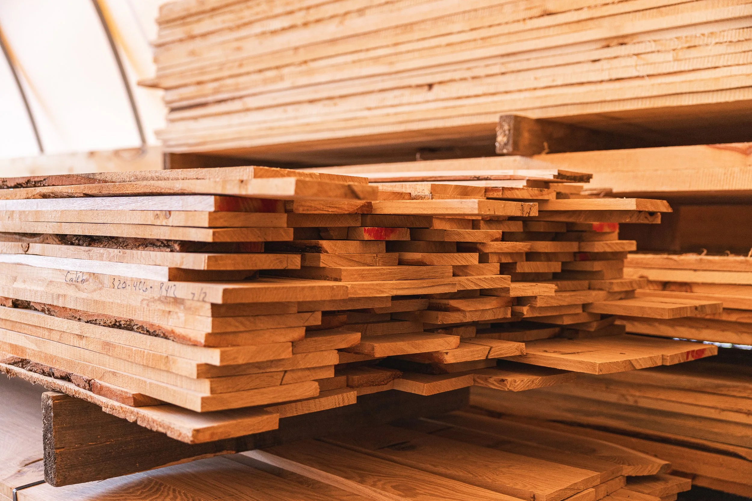 Stack of cut wooden boards in a woodworking shop