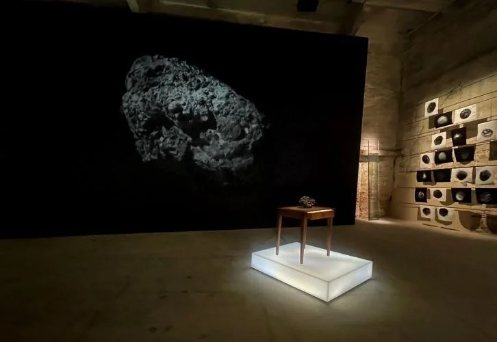 Two Moons video projection by Dawn DeDeaux, edited by Dave Greber, behind Meteor Study Desk in Studies of a Meteor: Time & Space, 61st Venice Biennale 2026.