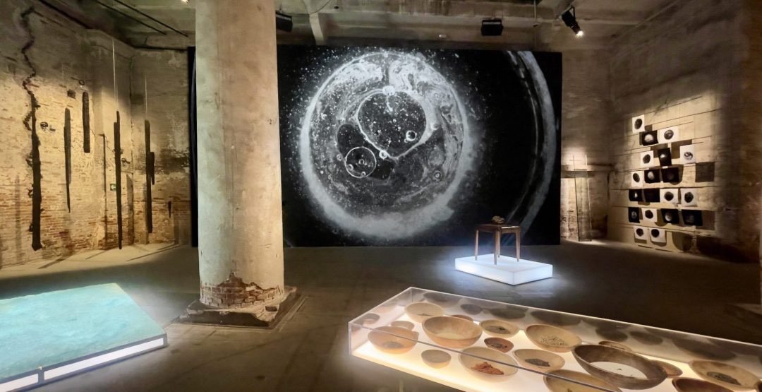 Installation view of Dawn DeDeaux's Studies of a Meteor: Time & Space at the Arsenale, 61st Venice Biennale, with Two Moons video projection edited by Dave Greber.