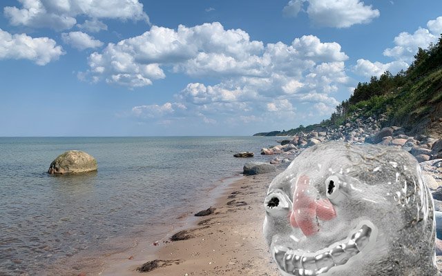 a 3D stone head on a sunny beach