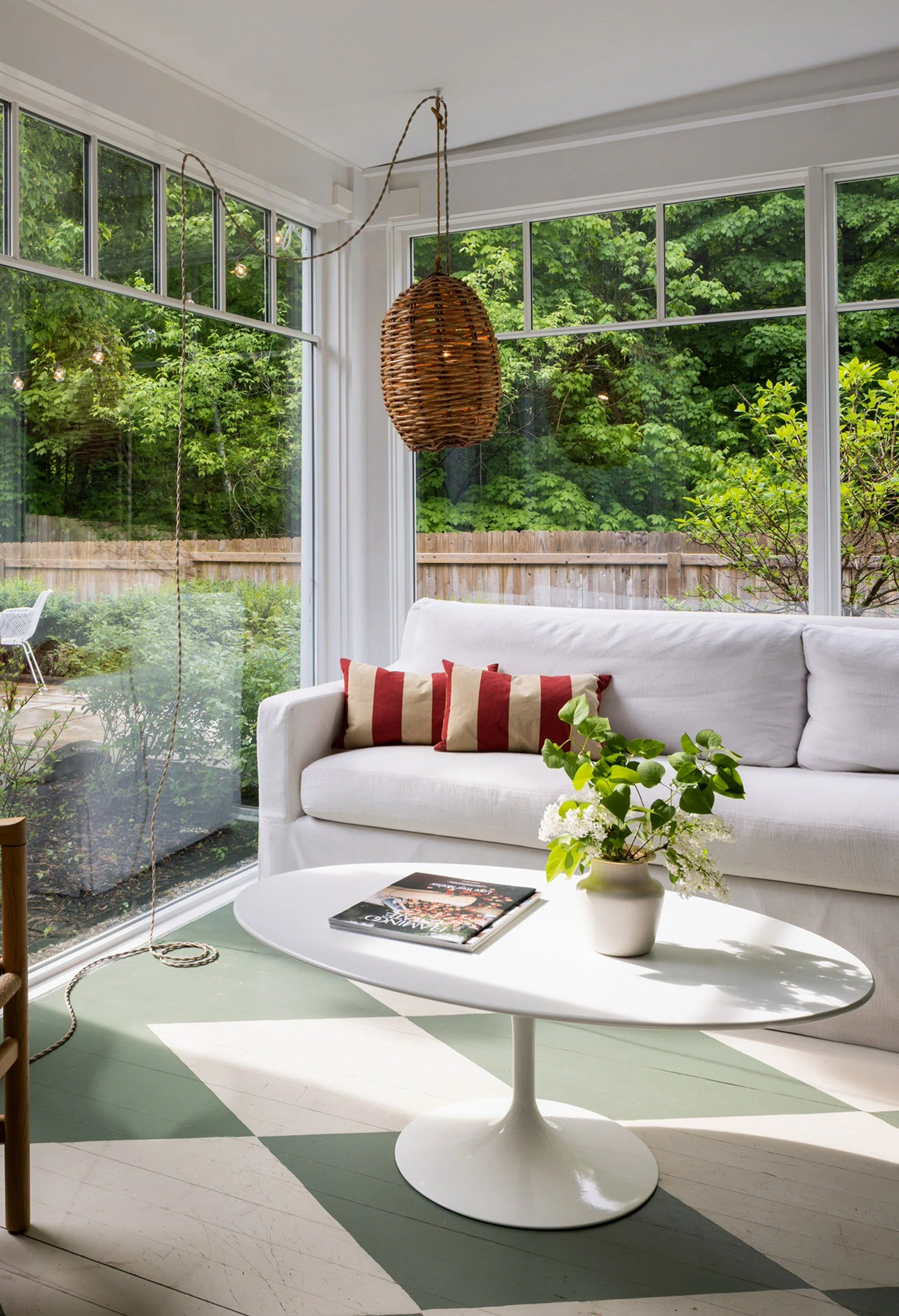 sunlit room with couch and tulip table