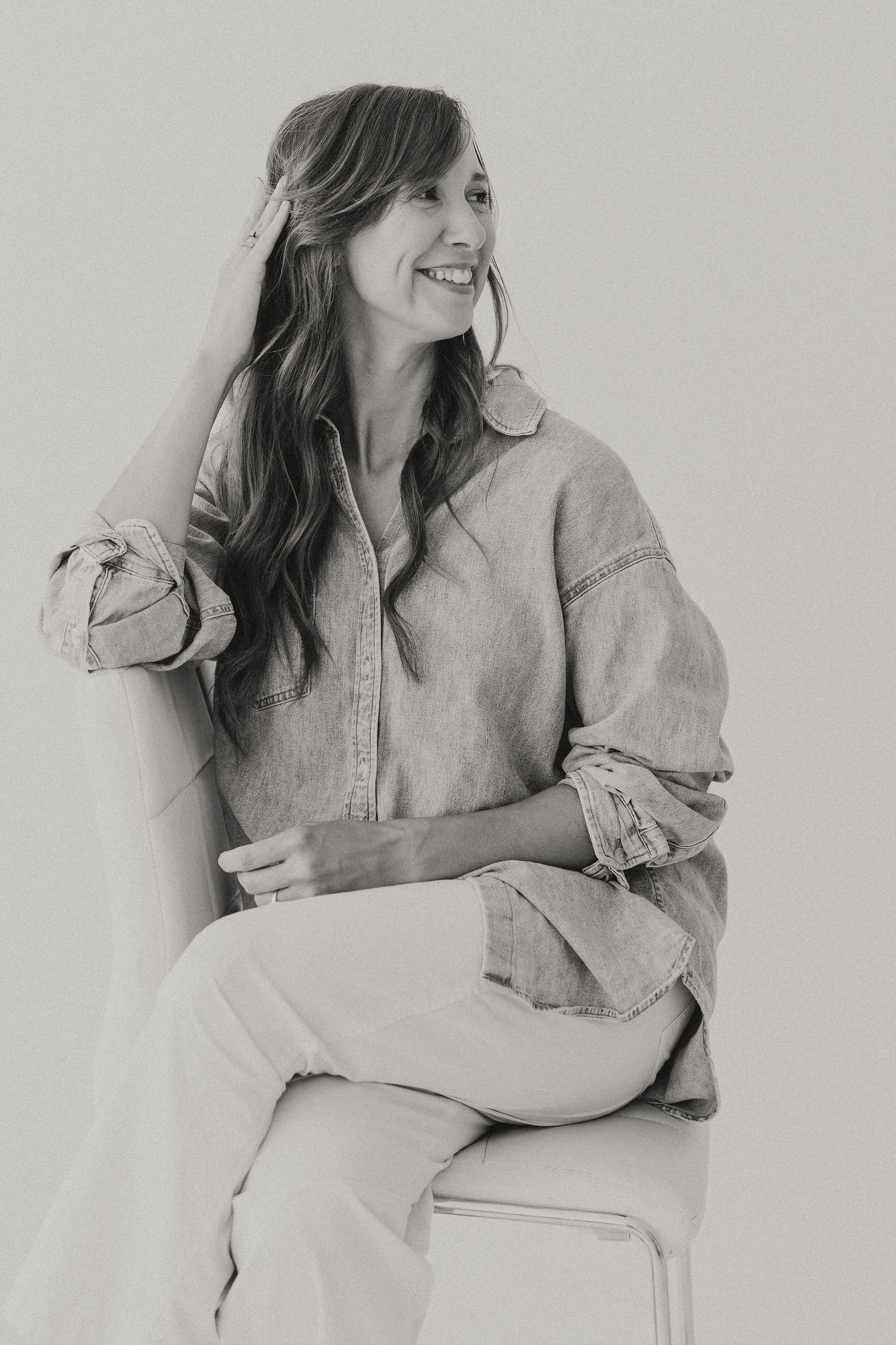 boutique design studio founder sitting on chair casually