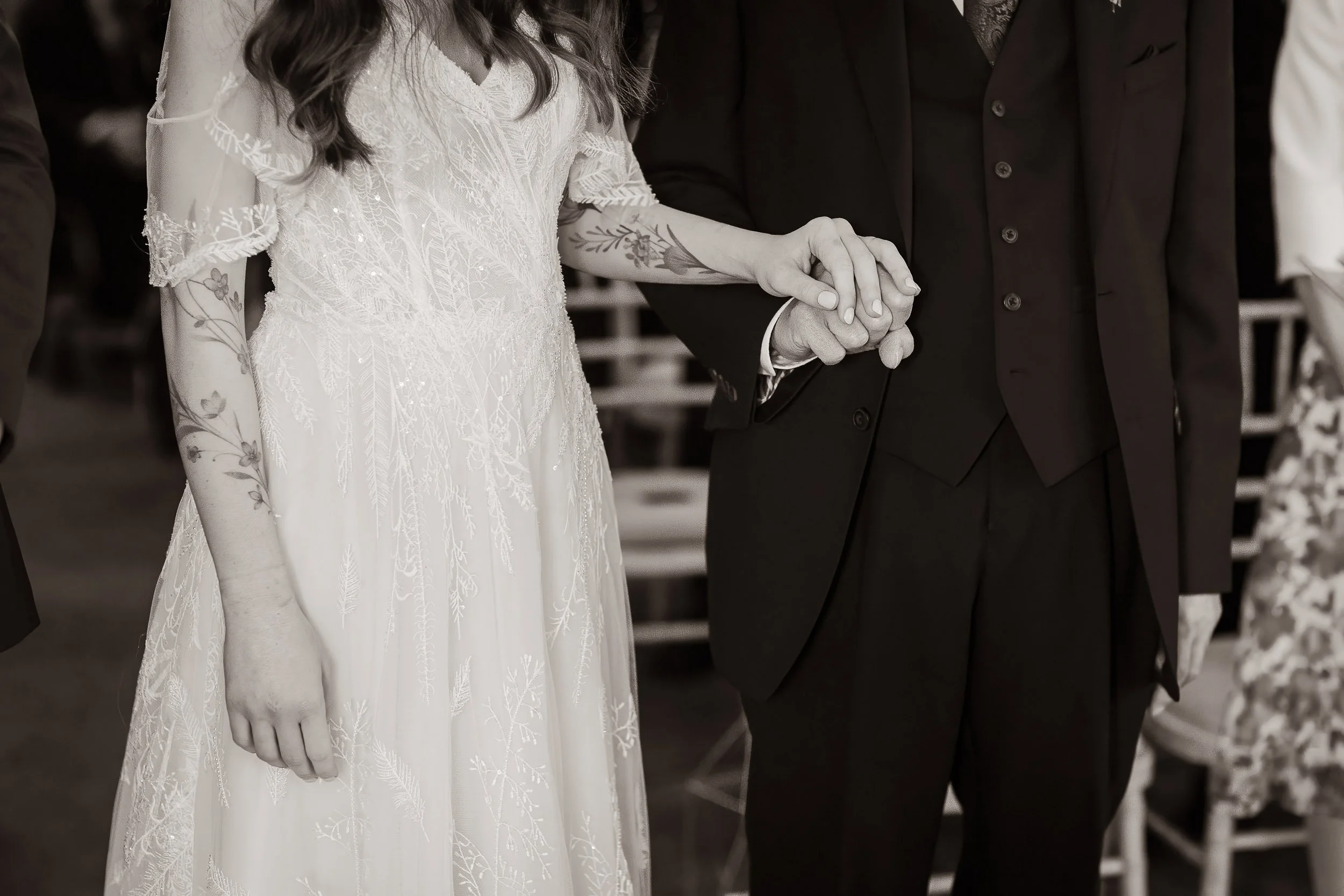 A bride and groom holding hands during a wedding ceremony.