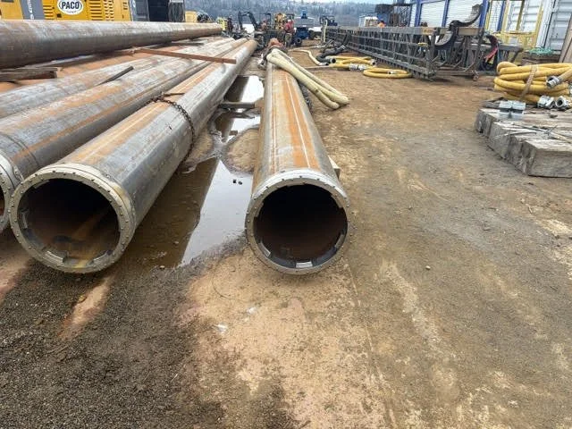 Steel piles stacked on concrete