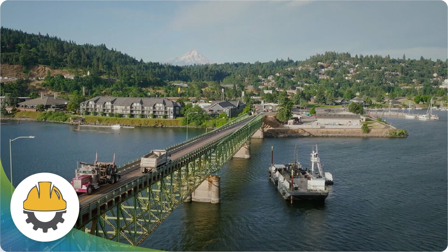 A bird’s eye view of the current Hood River-White Salmon Bridge, with a boat navigating the water below.