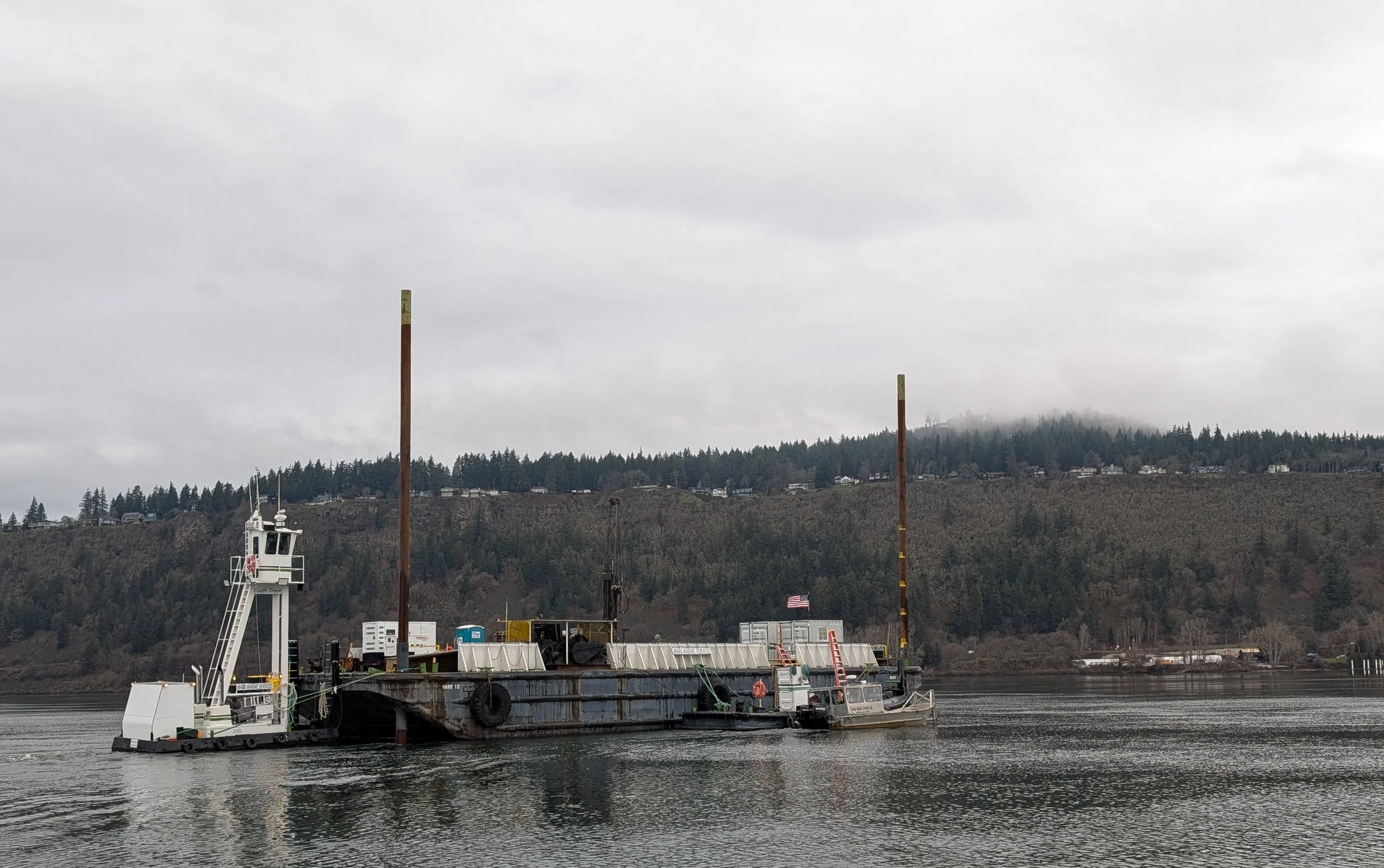 A geotechnical barge floats on the Columbia River