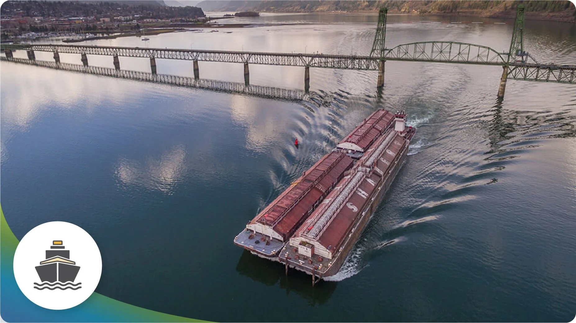 A cargo boat crossing under the Hood River-White Salmon Bridge.