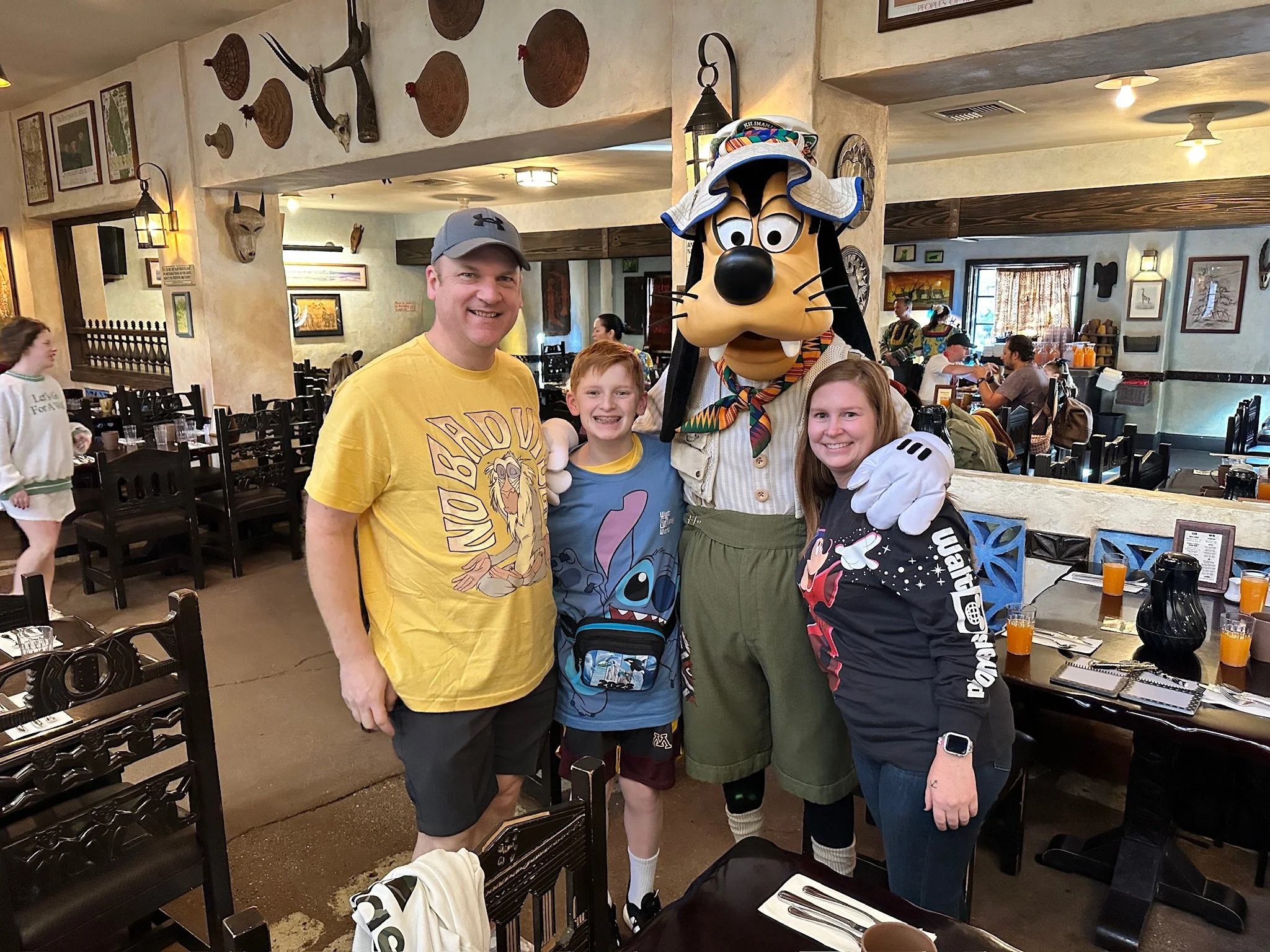 Travel Genie logo featuring a yellow magic lamp and colorful starbursts with purple text.