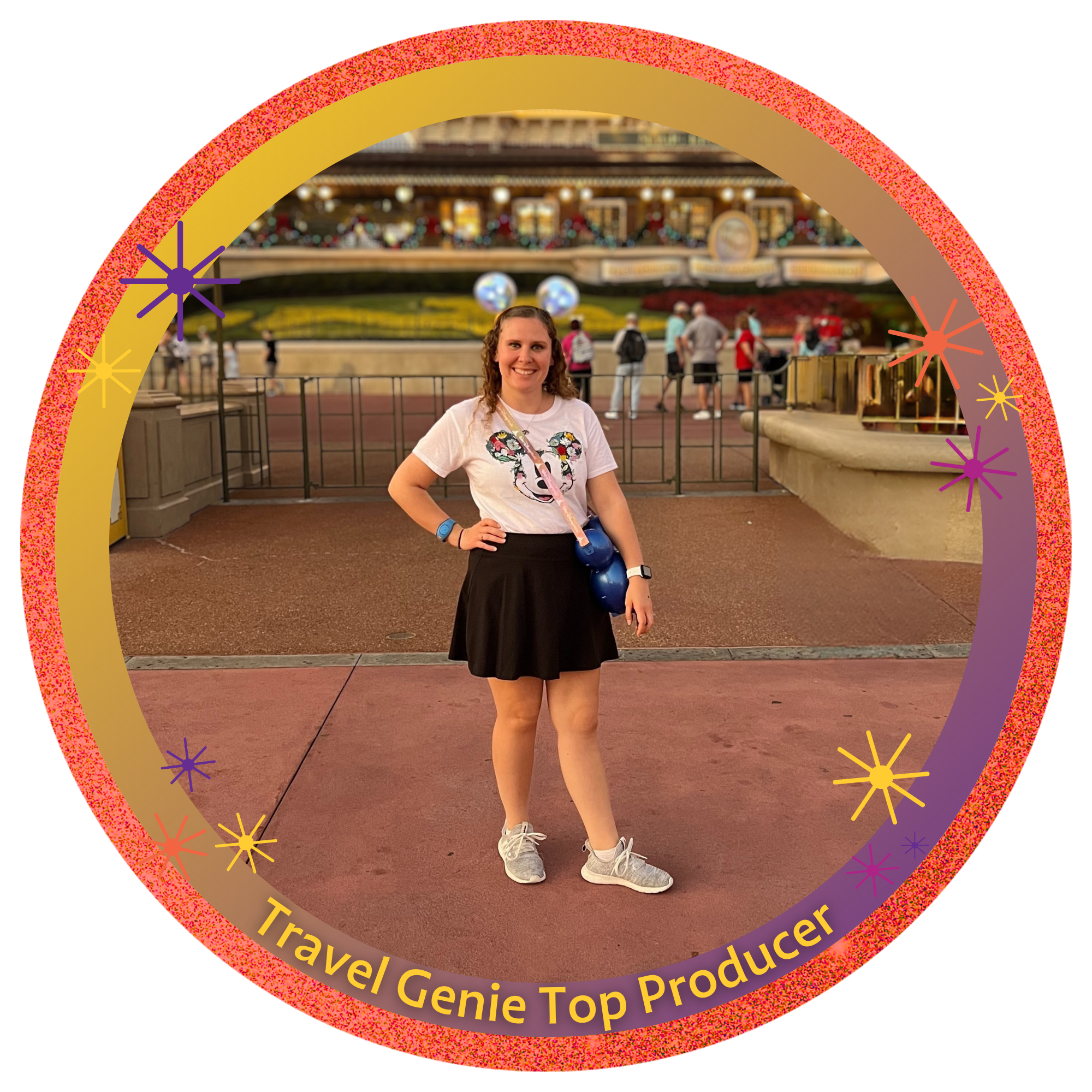 A woman standing in front of the entrance to Magic Kingdom at Disney World, wearing Minnie Mouse ears with glowing blue lights, smiling and posing for the photo. The iconic Main Street train station is visible in the background decorated for Christmas.