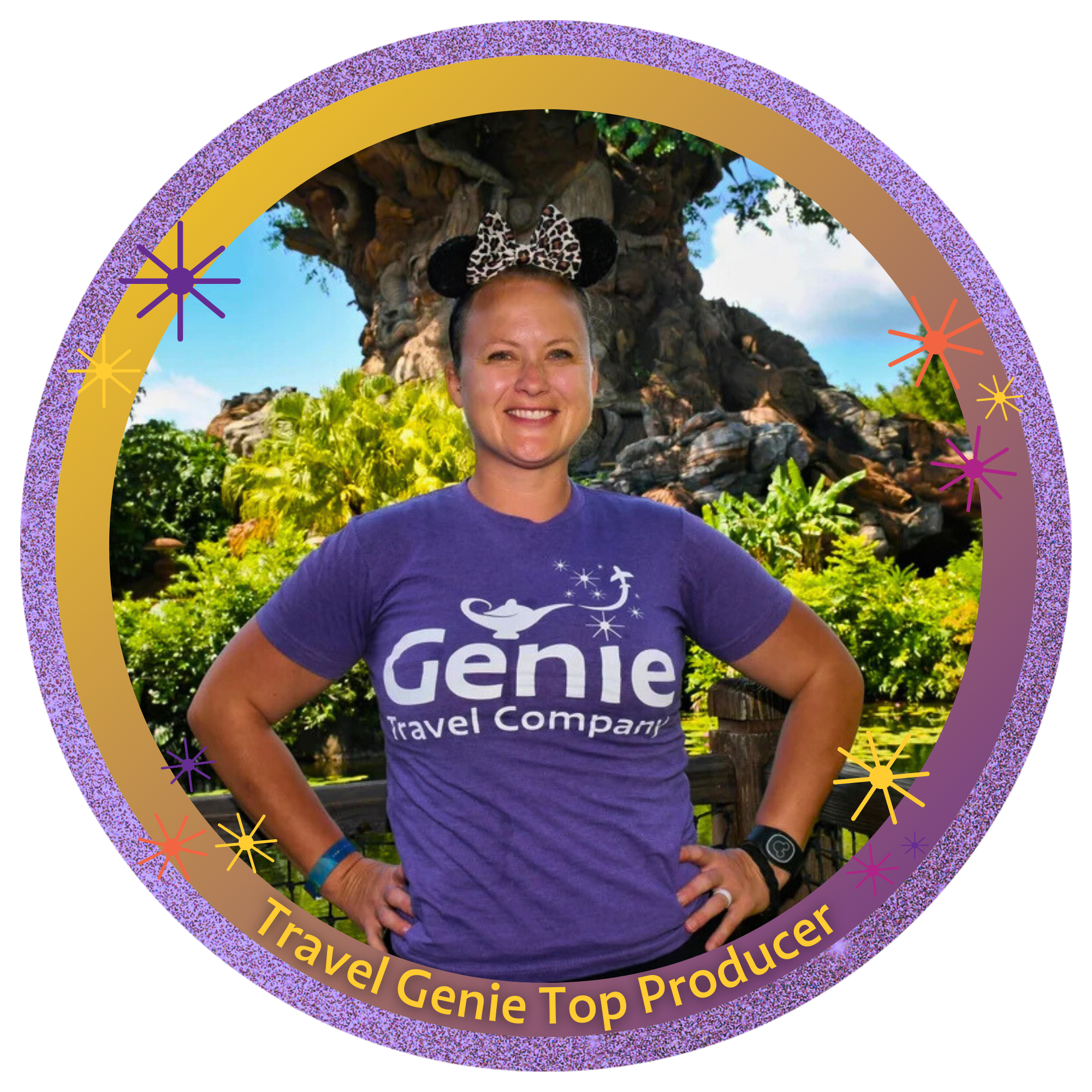 A woman standing outdoors in front of a large, themed tree, wearing a purple 'Genie Travel Company' t-shirt and Minnie Mouse ears headband with a leopard print bow.