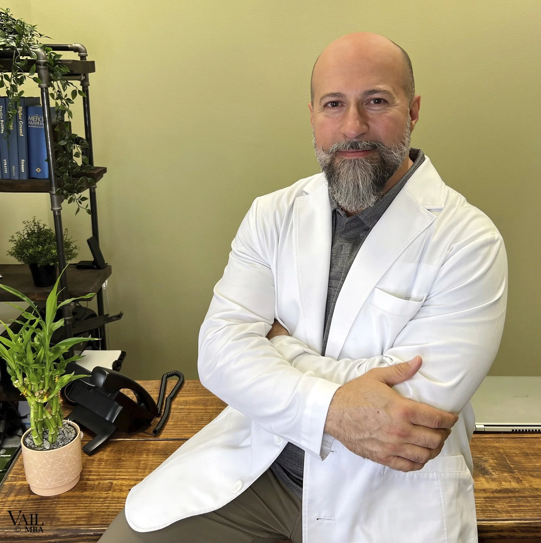 Dr Tino professional headshot in his office.