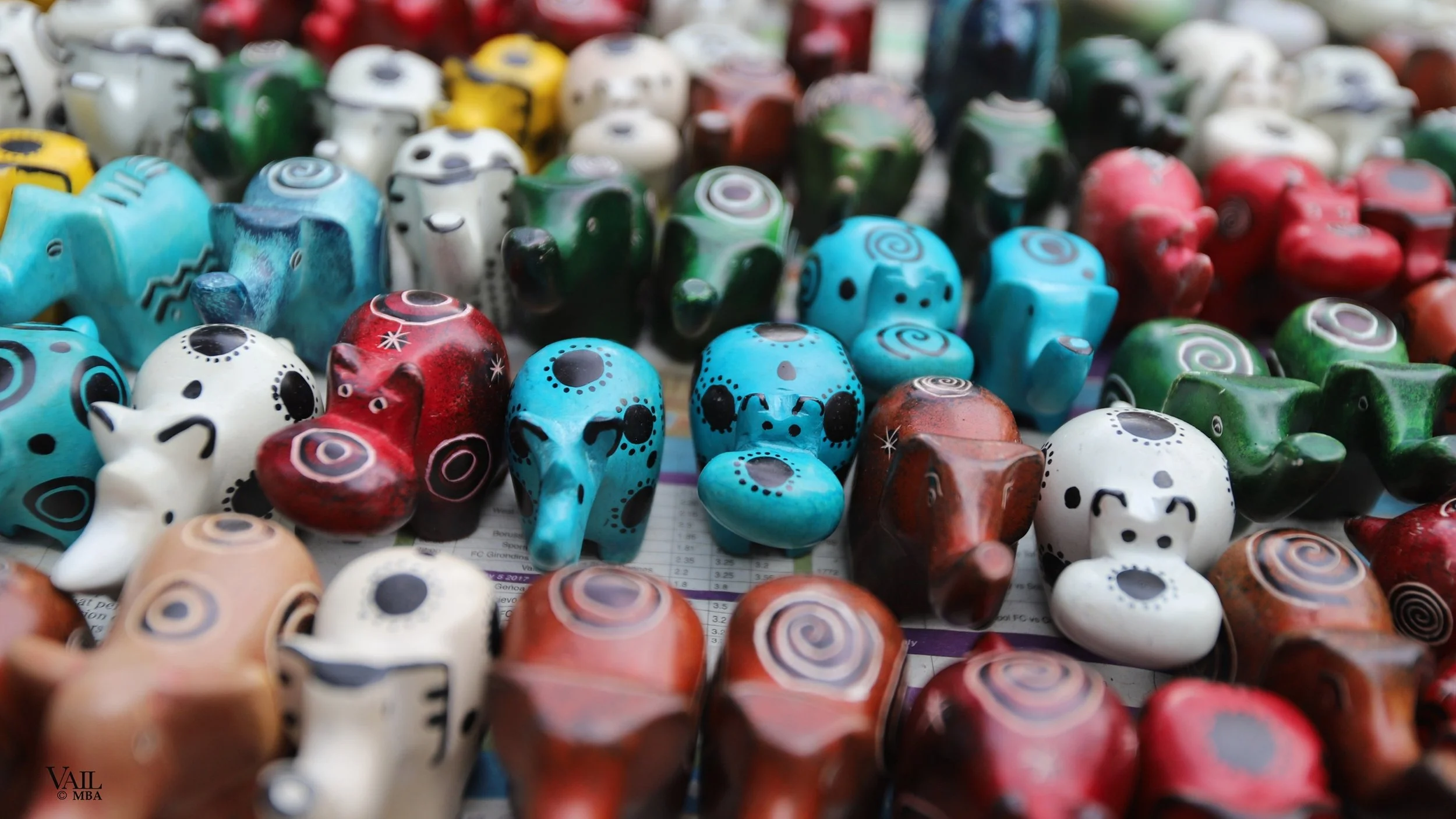 Colorful ceramic animal figurines on display at a market in Kenya.