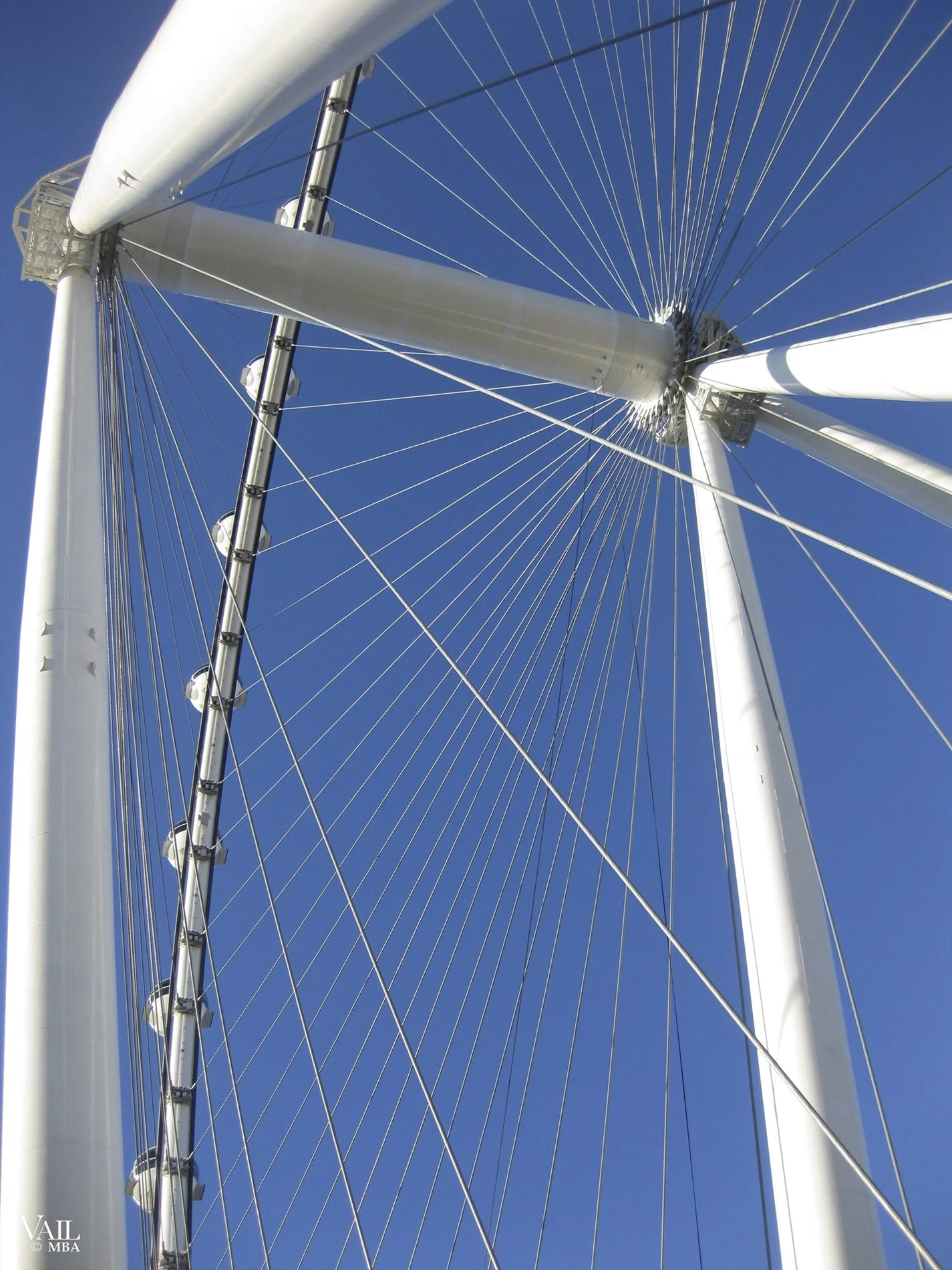 A section of the Las Vegas High Roller  Ferris wheel's white structural beams and pods.