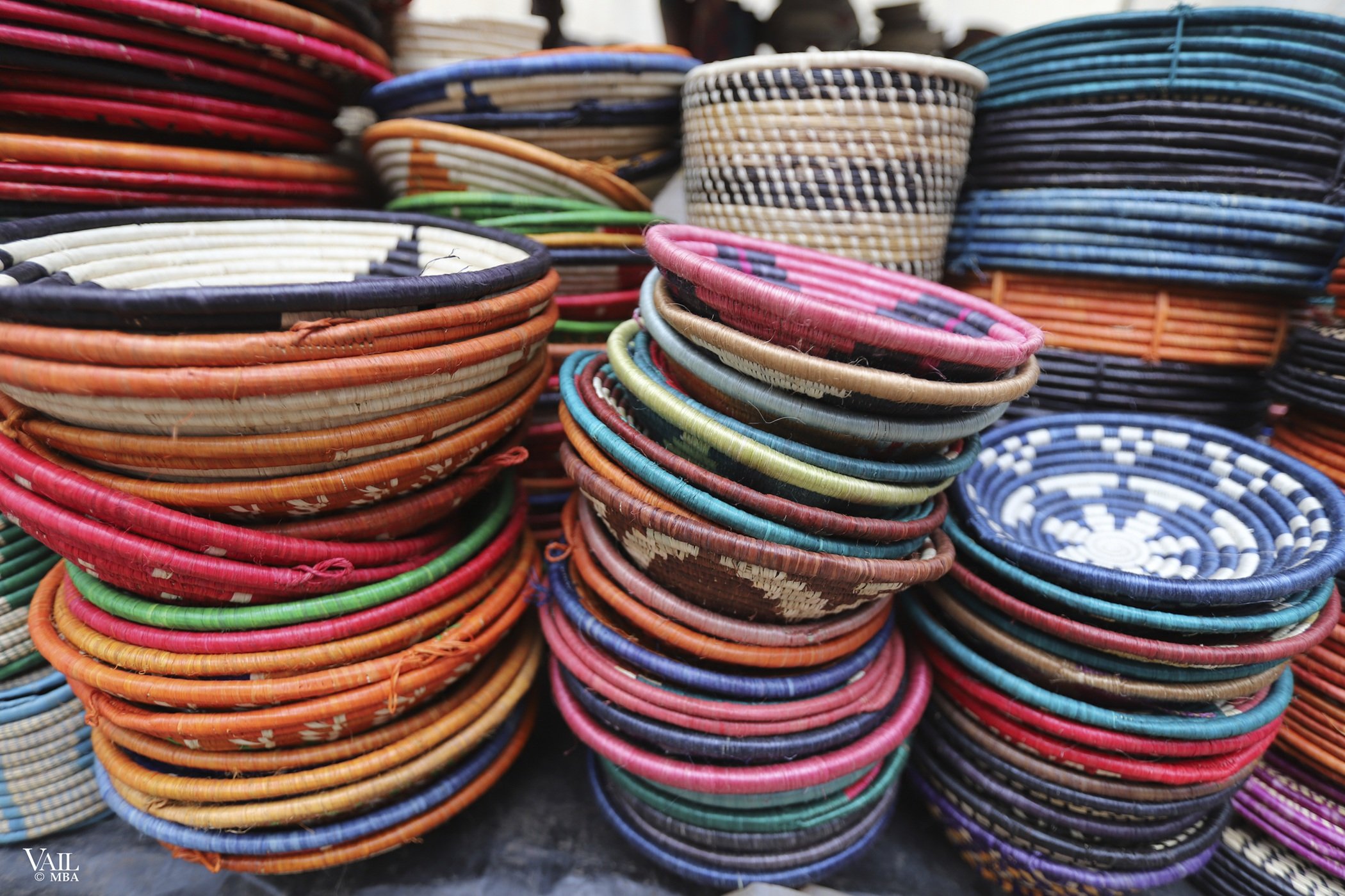 Colorful woven baskets stacked together in a Kenya market.