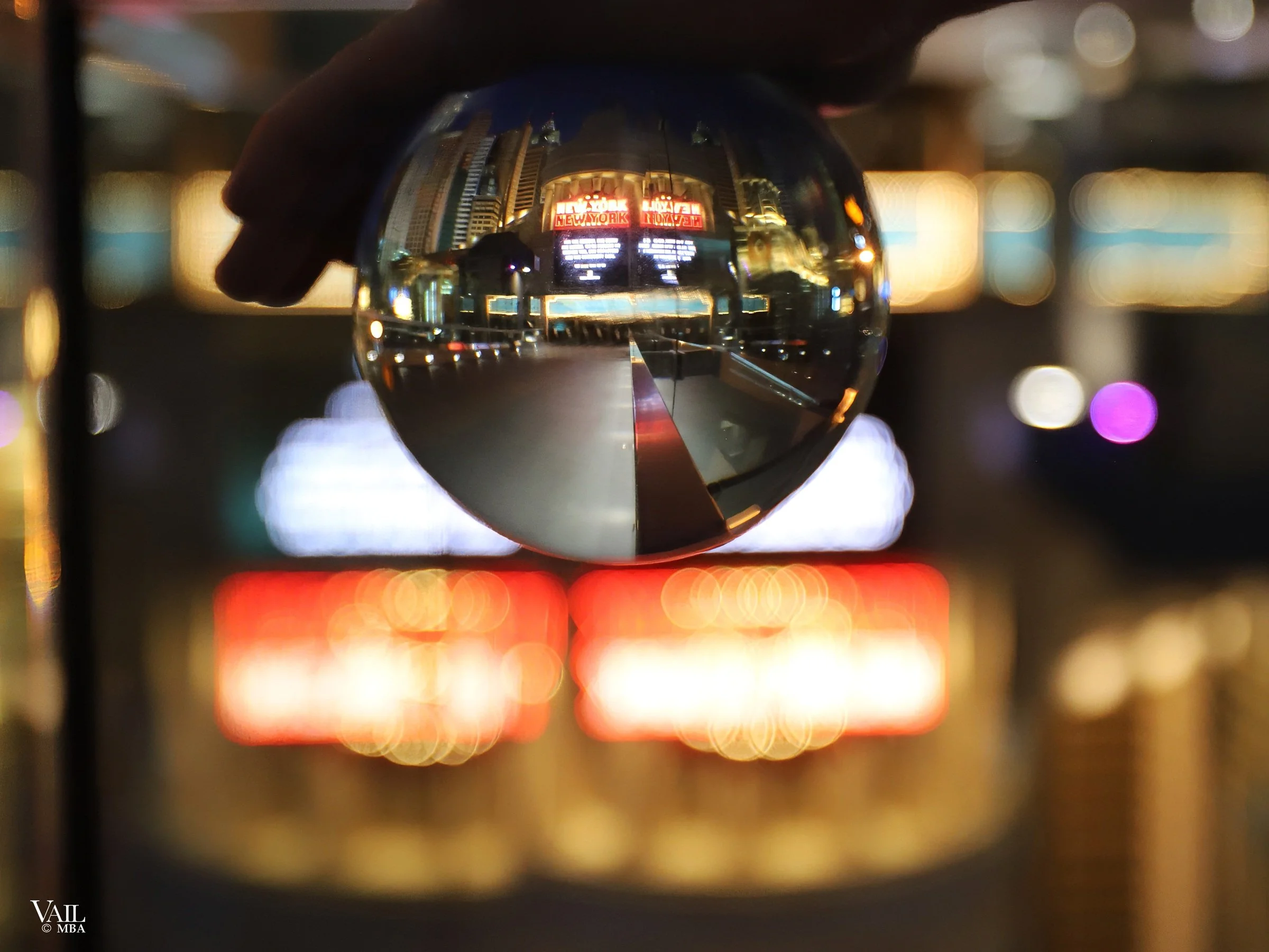 Covid era- New York New York marque as seen through a reflection globe.
