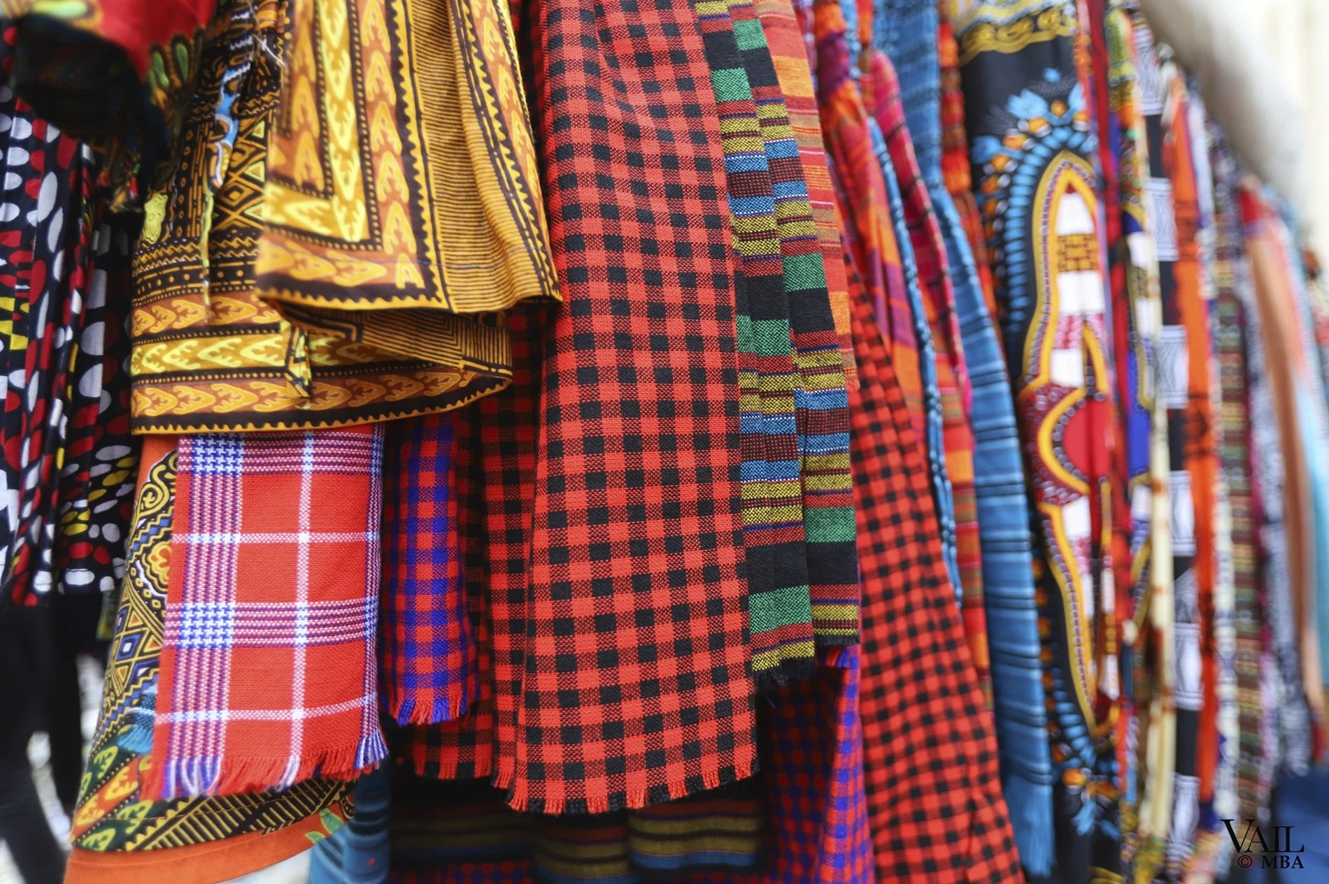 Kenya - Colorful African print fabrics hanging on a rack.