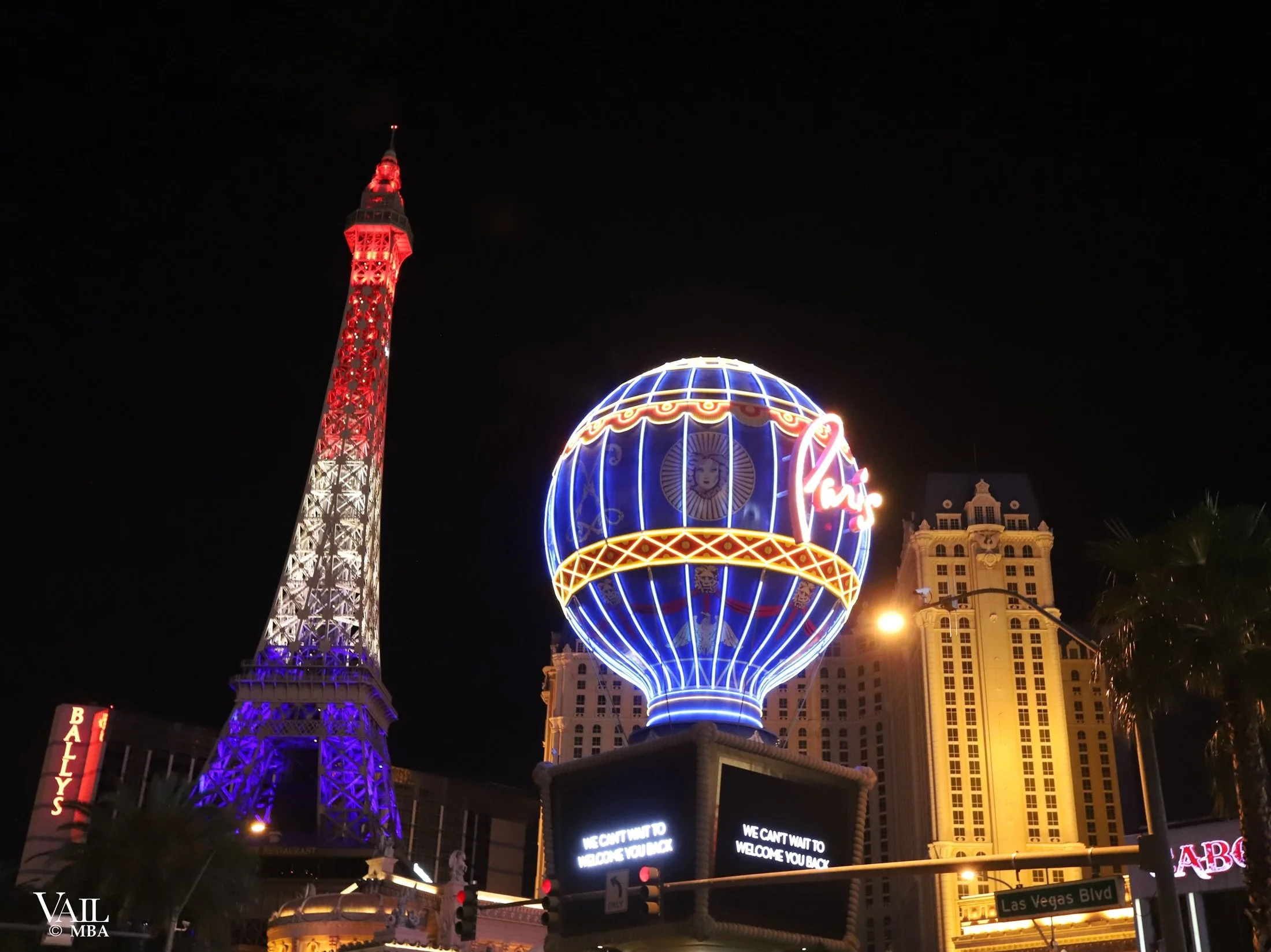 Covid era night photo of the Paris Hotel hot air balloon and Eiffel Tower.