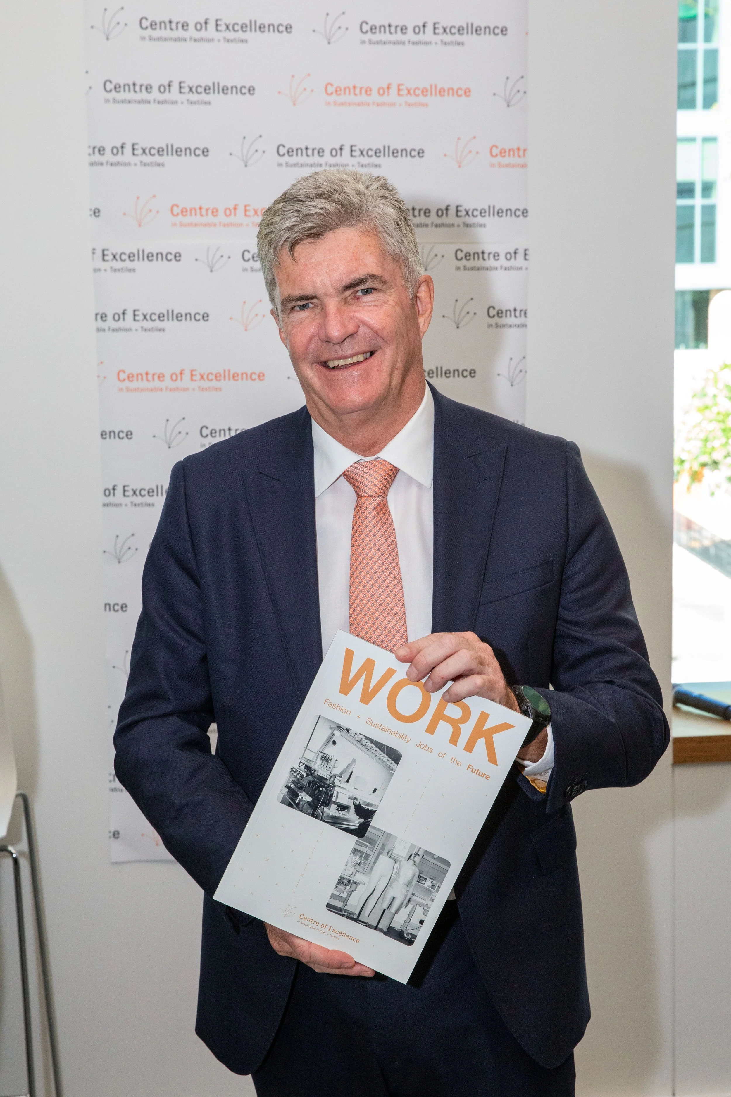 Image of The Hon Steve Whan holding a printed copy of the WORK report