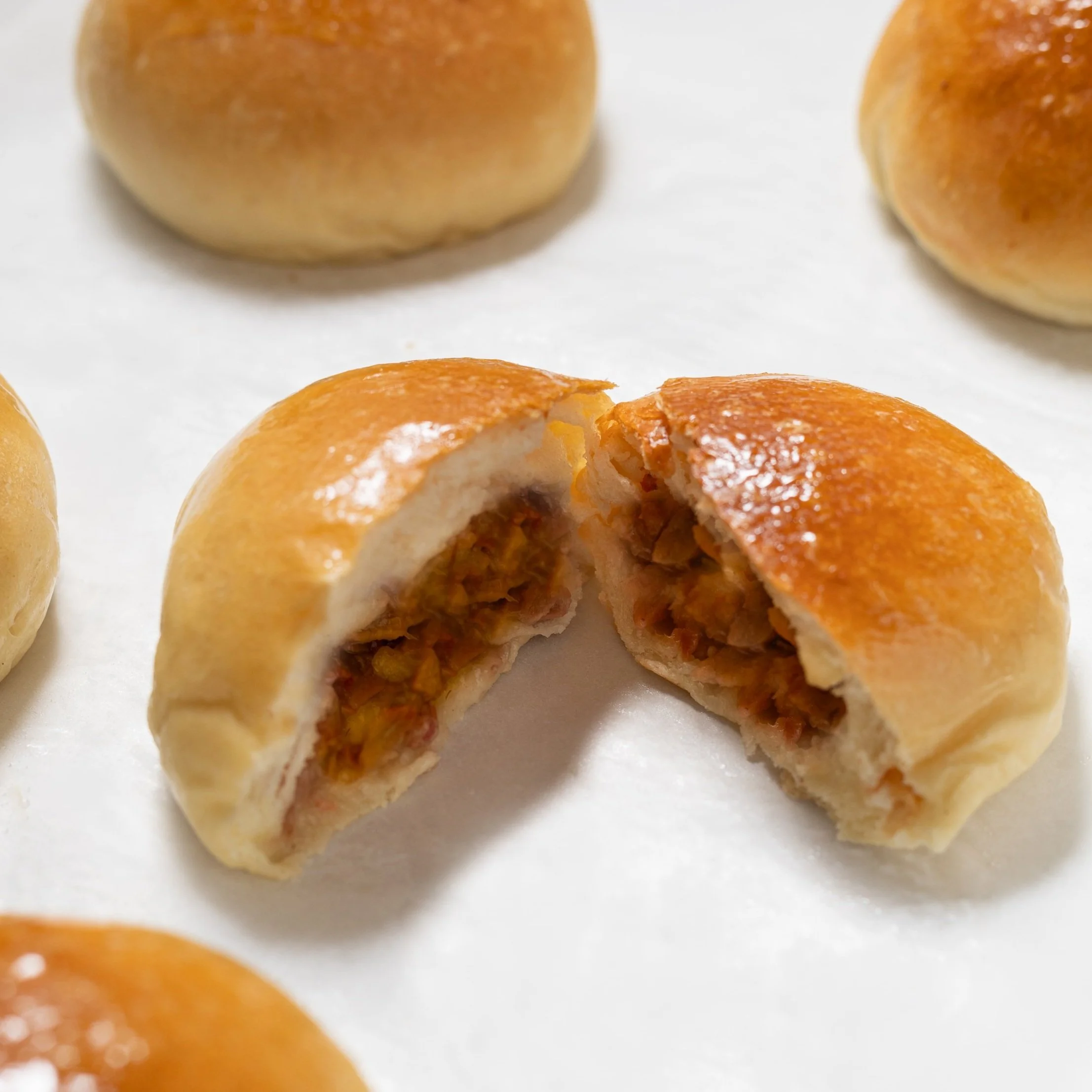 Top-Rated Chinese baked BBQ barbeque pork bun filled with sweet and savory barbecued pork.
