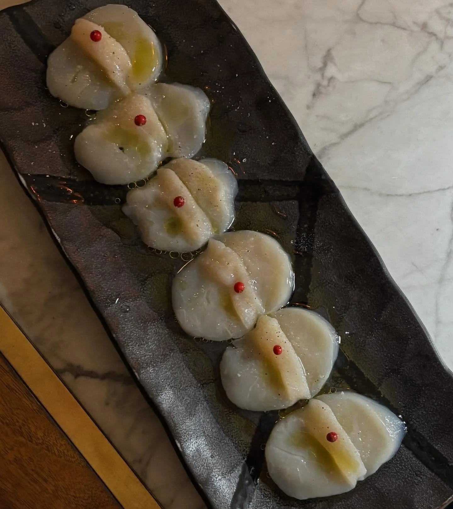 Today I feature one of my favorites here at Sushi Note, the Scallop Carpaccio! Topped with Lemon, Truffle Salt, Olive oil and Pink pepper corns, this is a bite you absolutely cannot miss out on! Come take a look at our sashimi and carpaccio plates fo