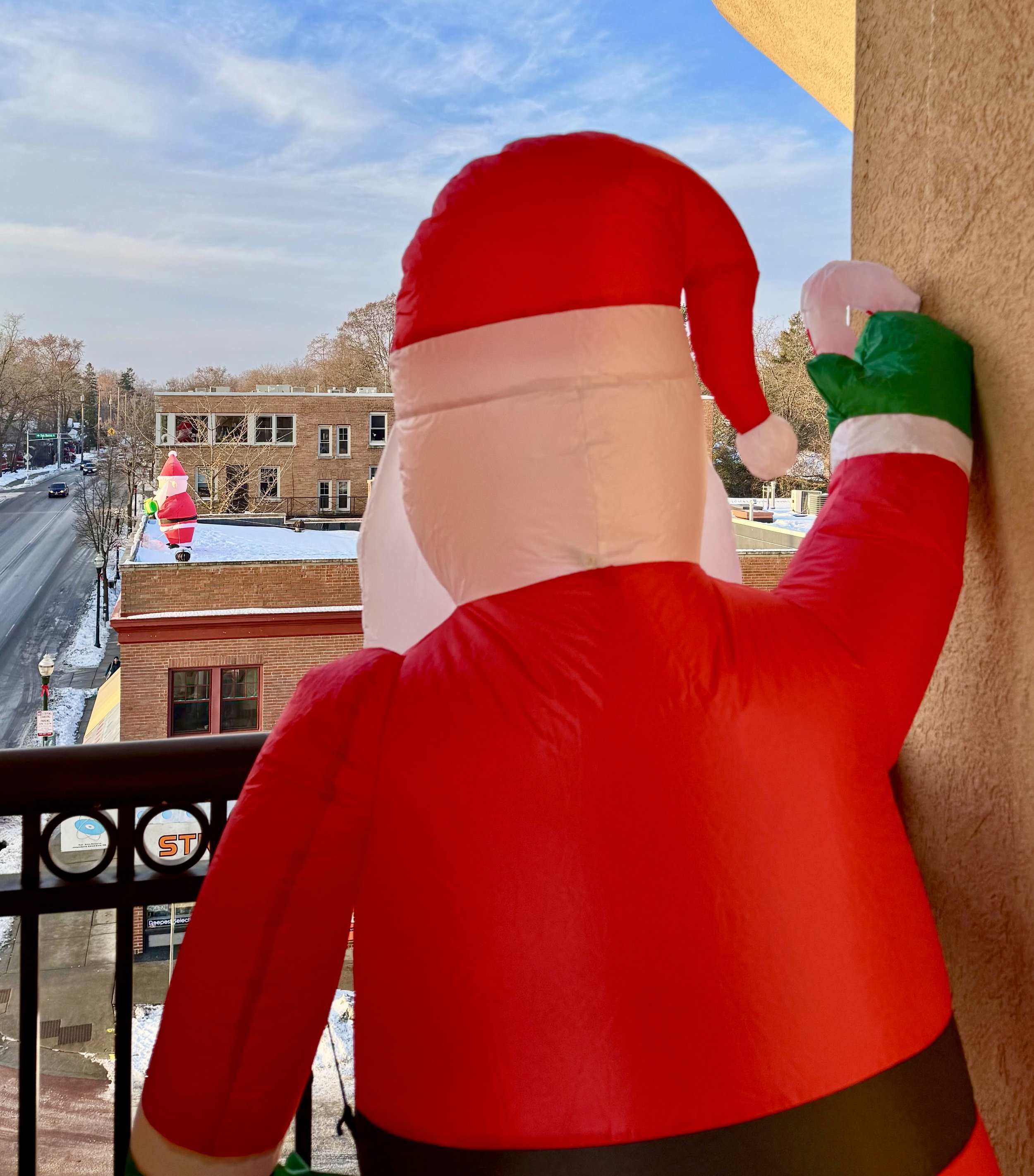View of Santa inflatable from a balcony down a snowy Monroe Street. Photo by Laurie Elwell
