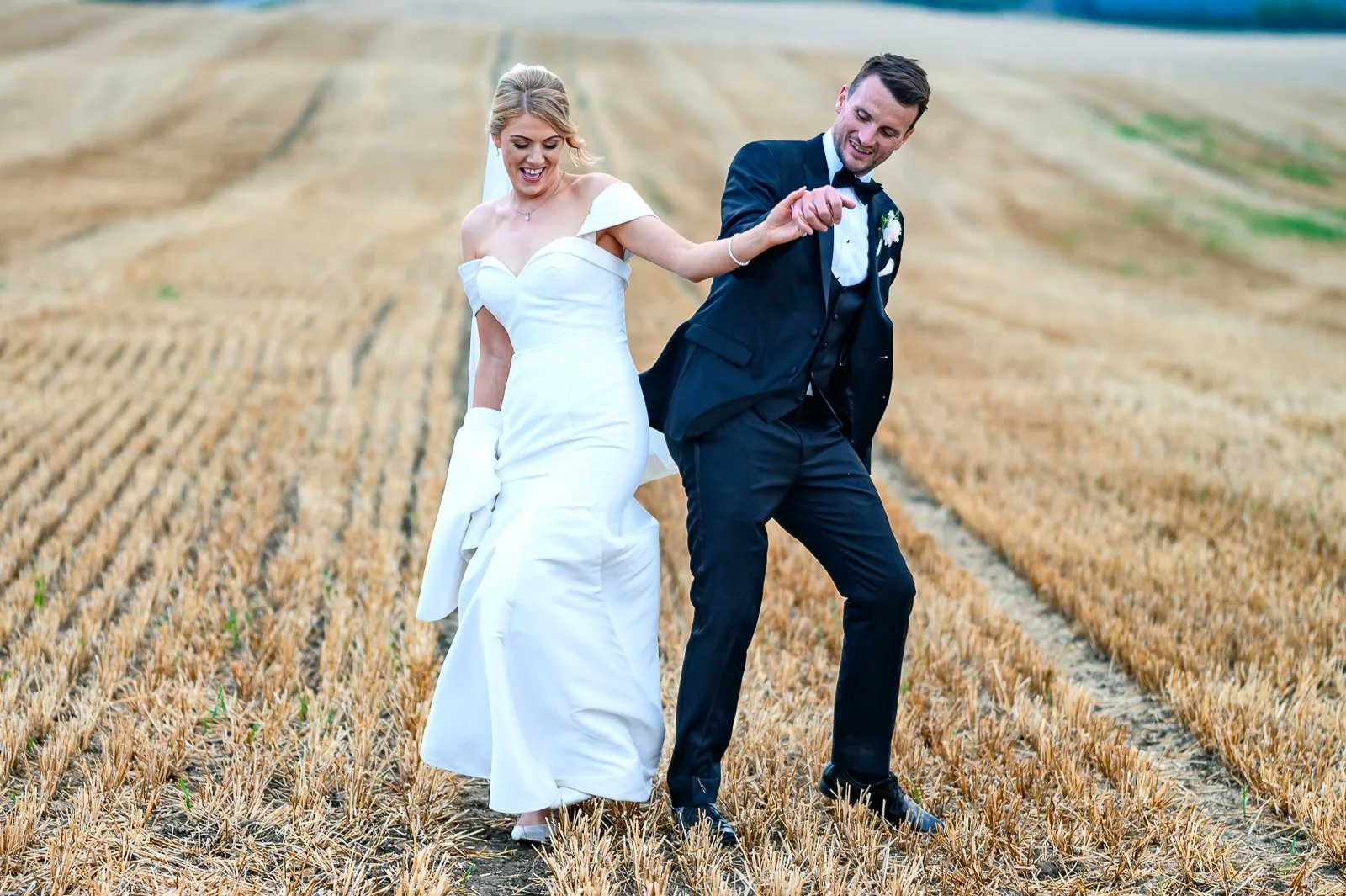 castle-farm-barn-wedding-bride-and-groom-in-field