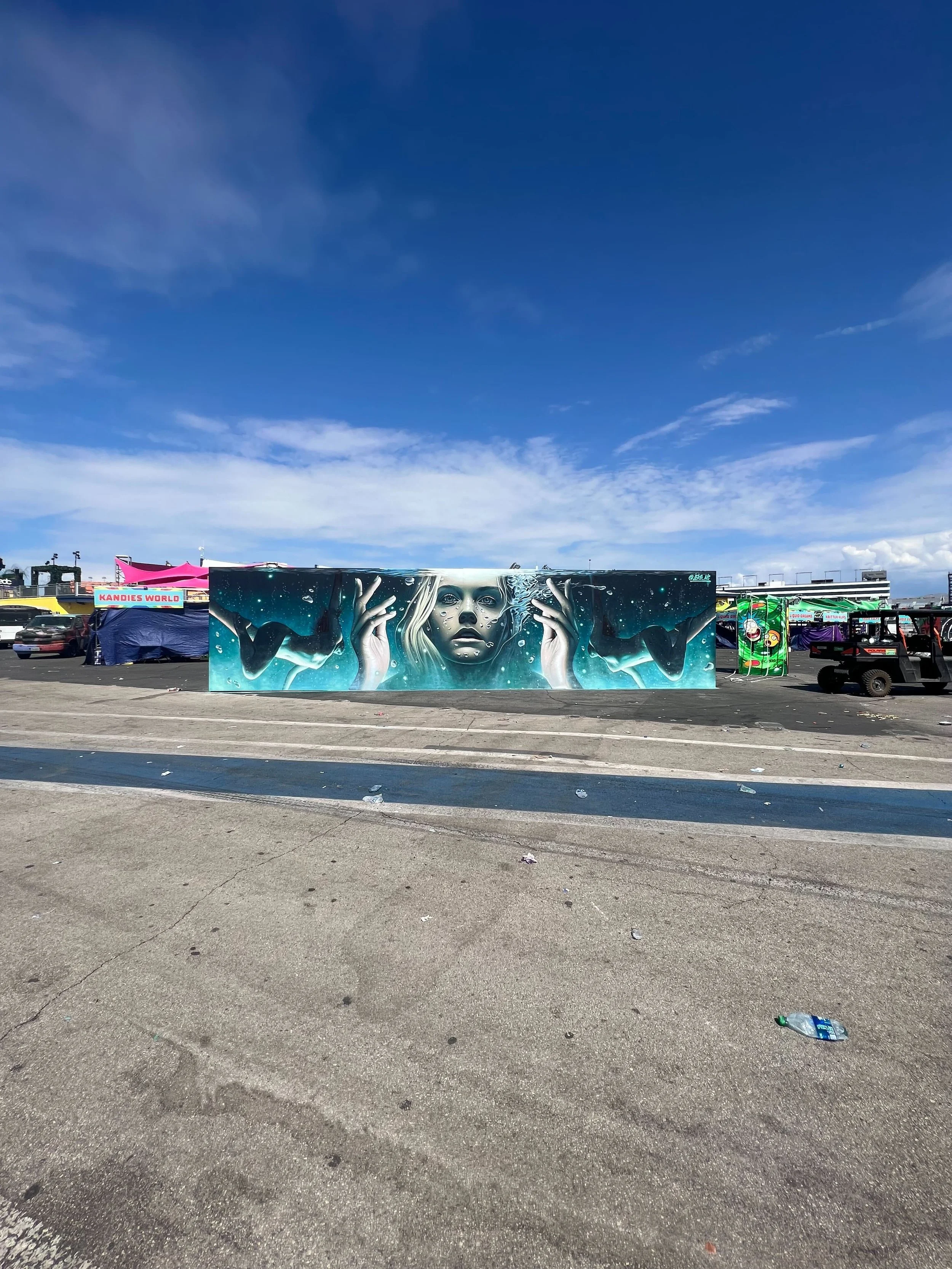 A large mural of a woman underwater with her hands raised