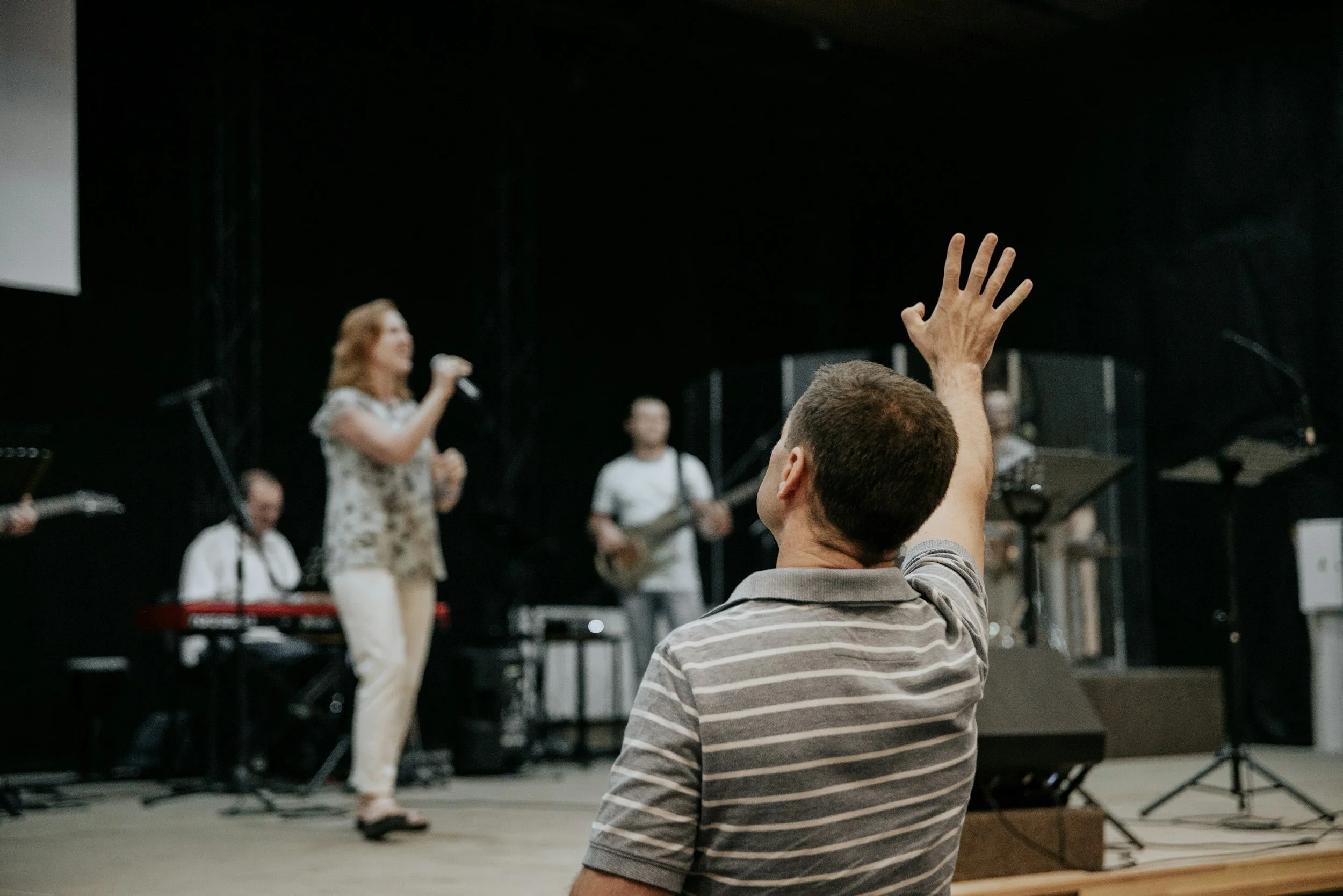 man raising his hand during a speech or music performance