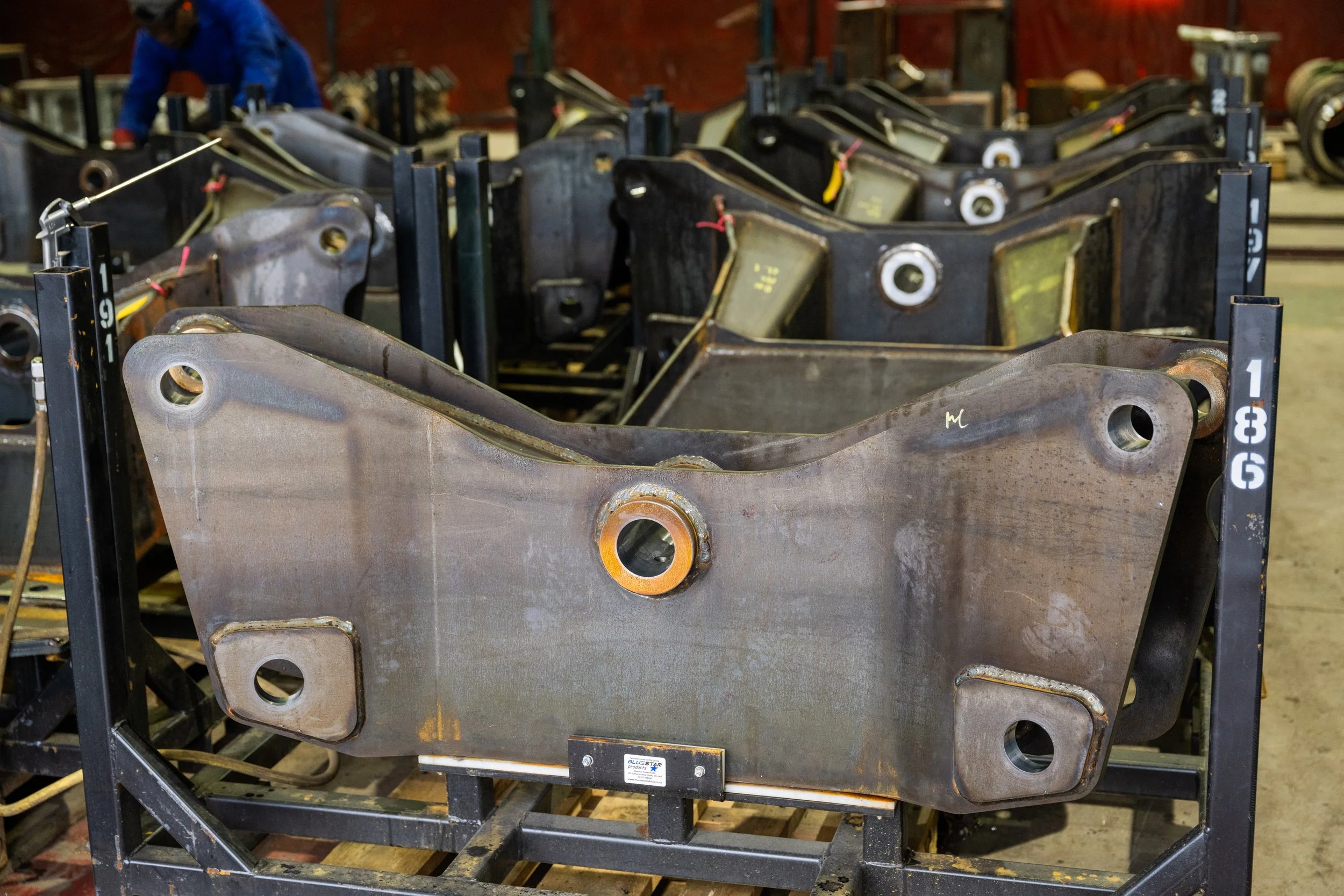 Industrial machine part on a metal worktable in a workshop, with metal shavings and sparks.