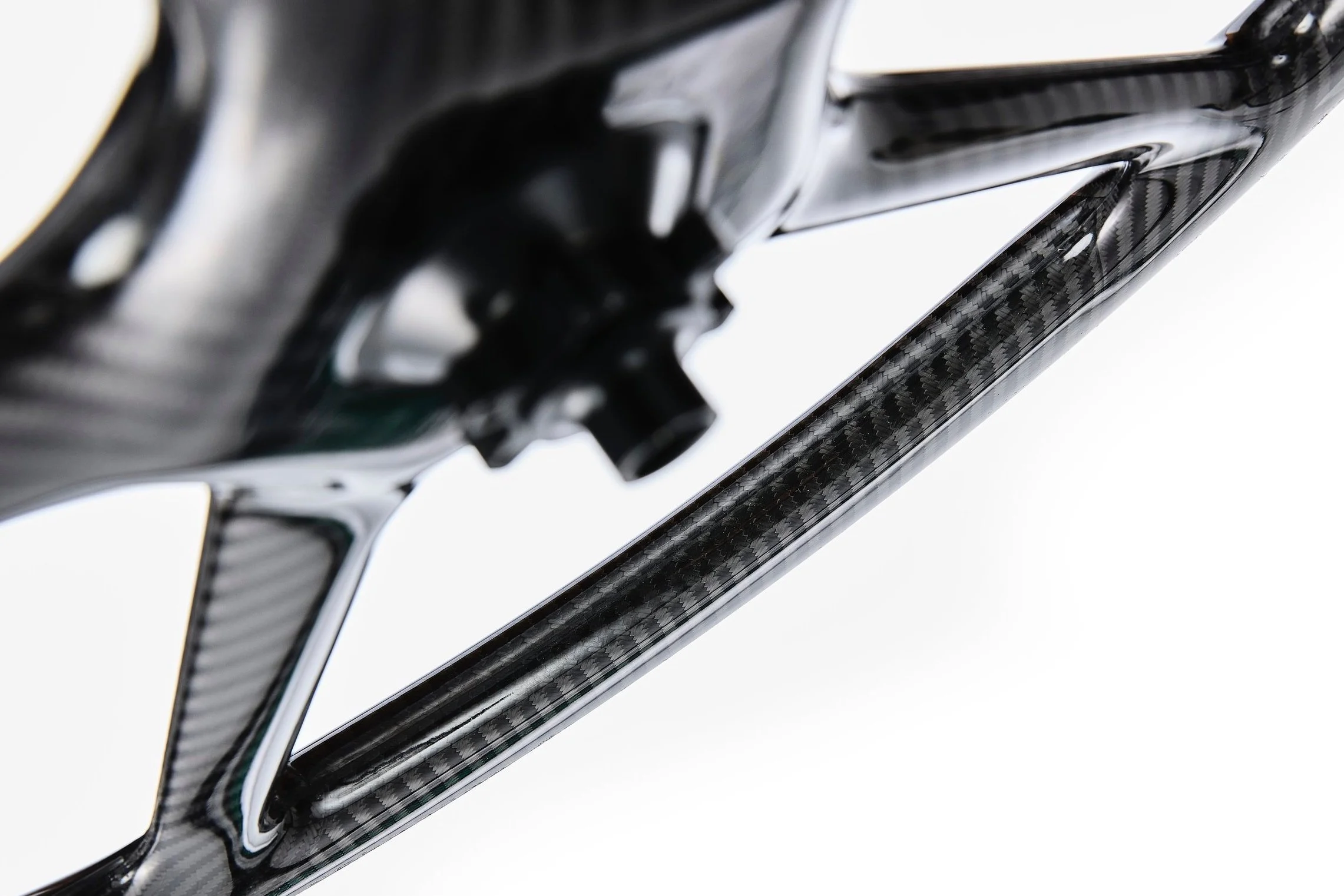 Close-up view of a carbon fiber bicycle wheel showing the spokes and hub.