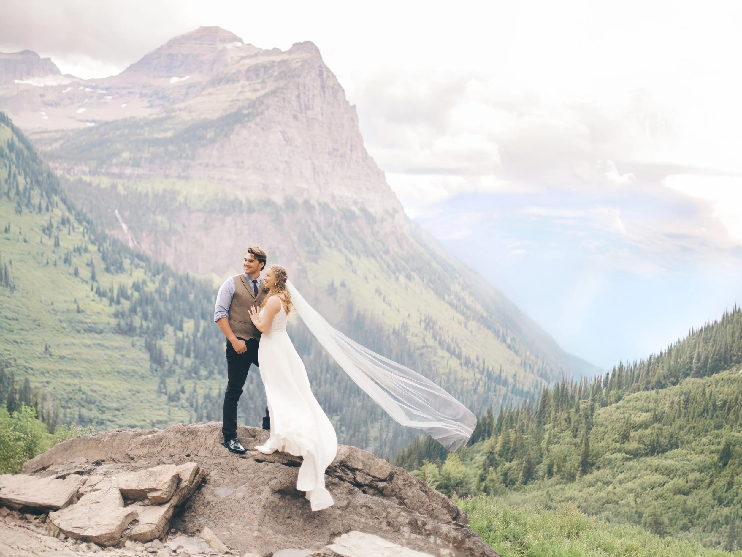 Film Wedding Photography Glacier National Park Montana Couple smiling with mountain views