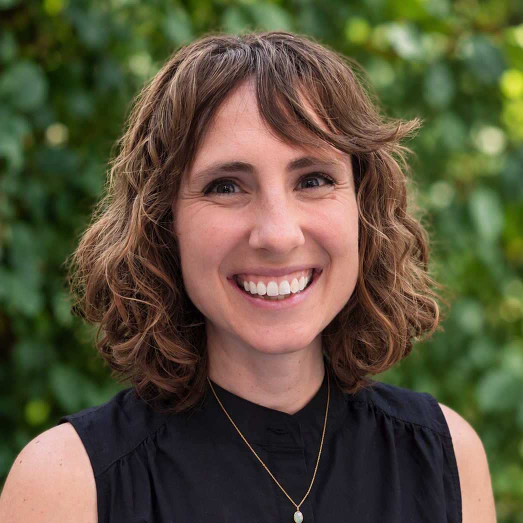 person with brown hair and a black shirt.