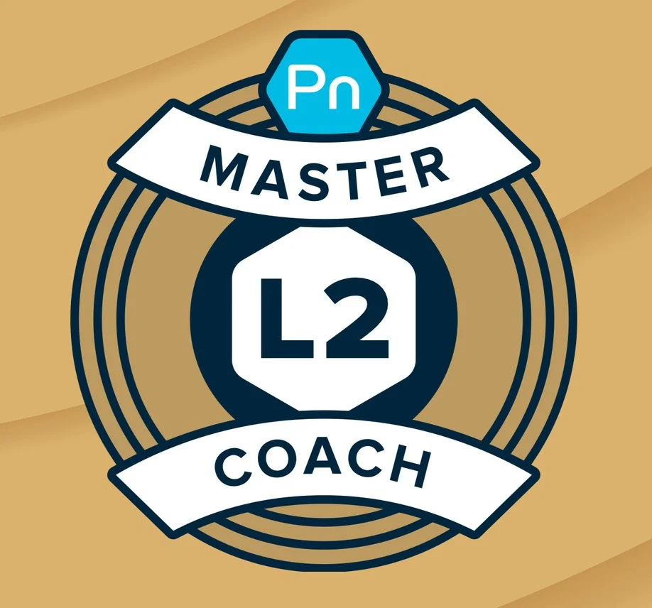 Graphic badge with the Adobe Photoshop logo, the words 'Master,' 'L2,' and 'Coach' arranged around it.
