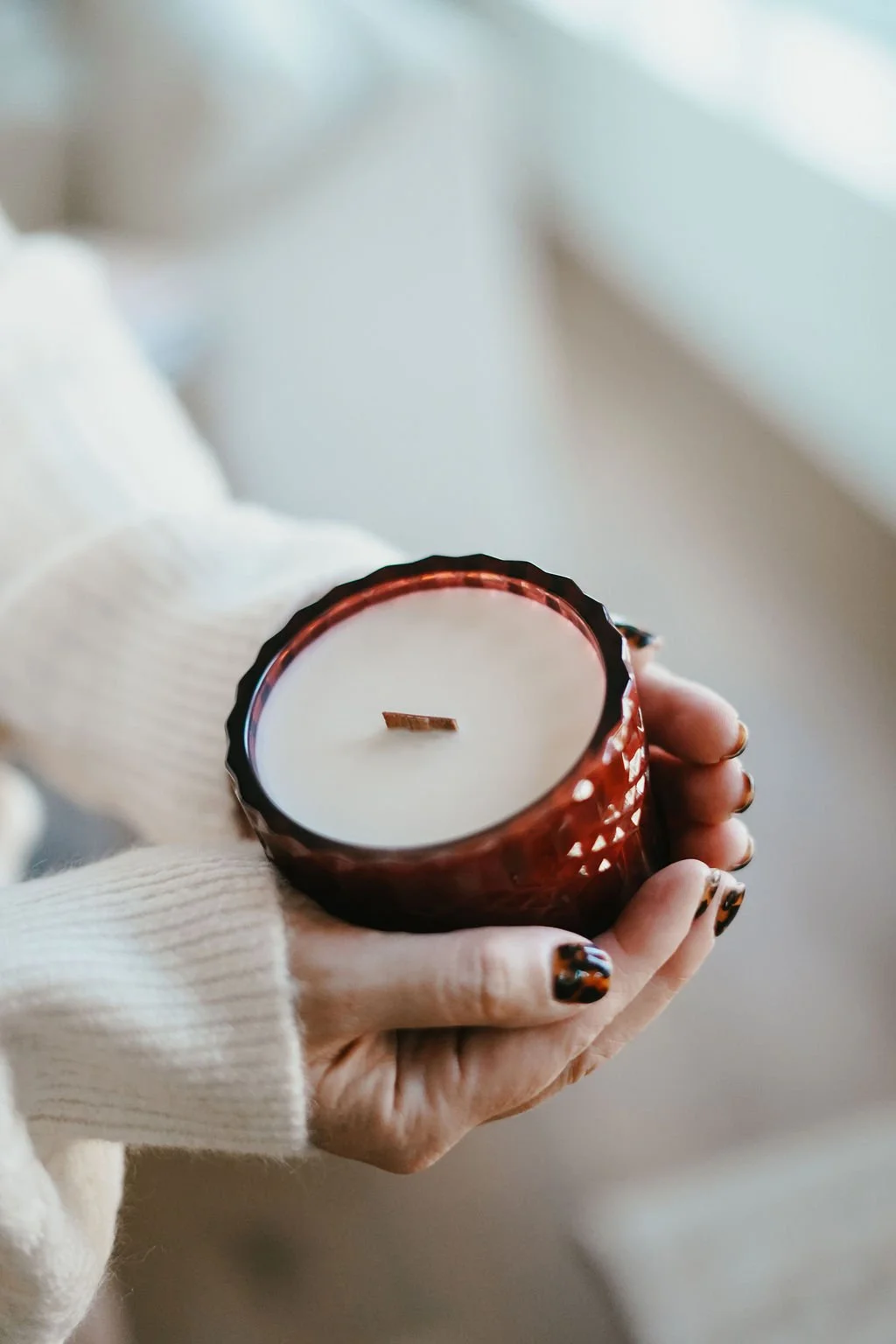 Woman lighting a candle with a lighter.