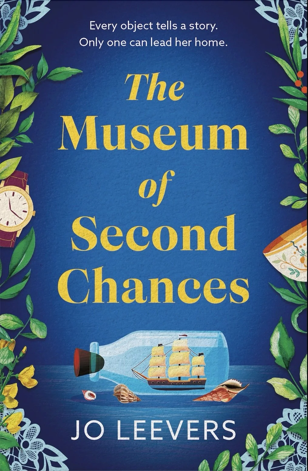 The cover of the book titled 'The Museum of Second Chances' by Jo Leevers, featuring a blue background with green leaves, a sailing ship enclosed in a glass case, and decorative elements like a watch and seashells.