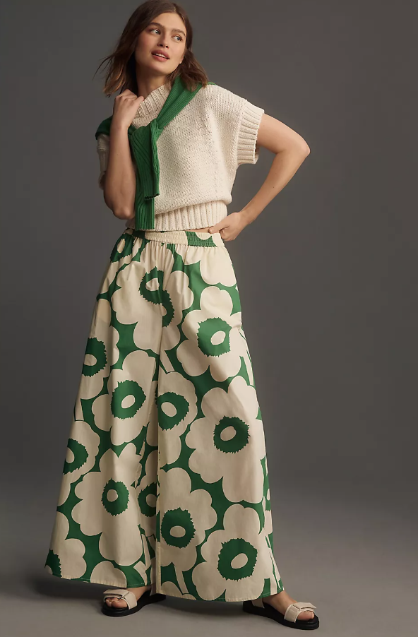 Model wearing Marimekko green floral pattern wide leg pants and cream knit top