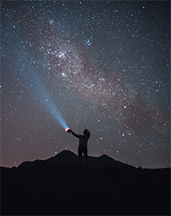 Flashlight pointed at starry sky