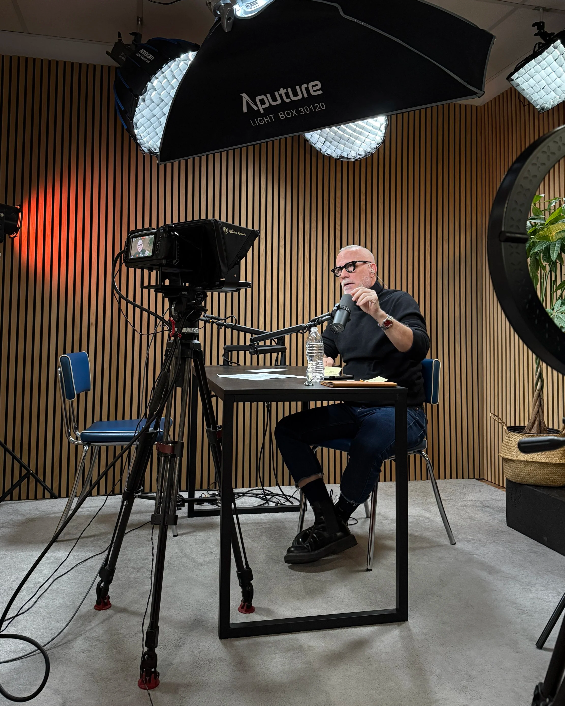 Guest recording at Upstate Podcast Studio in Kingston, NY — professional lighting, camera, and teleprompter setup for remote podcast sessions