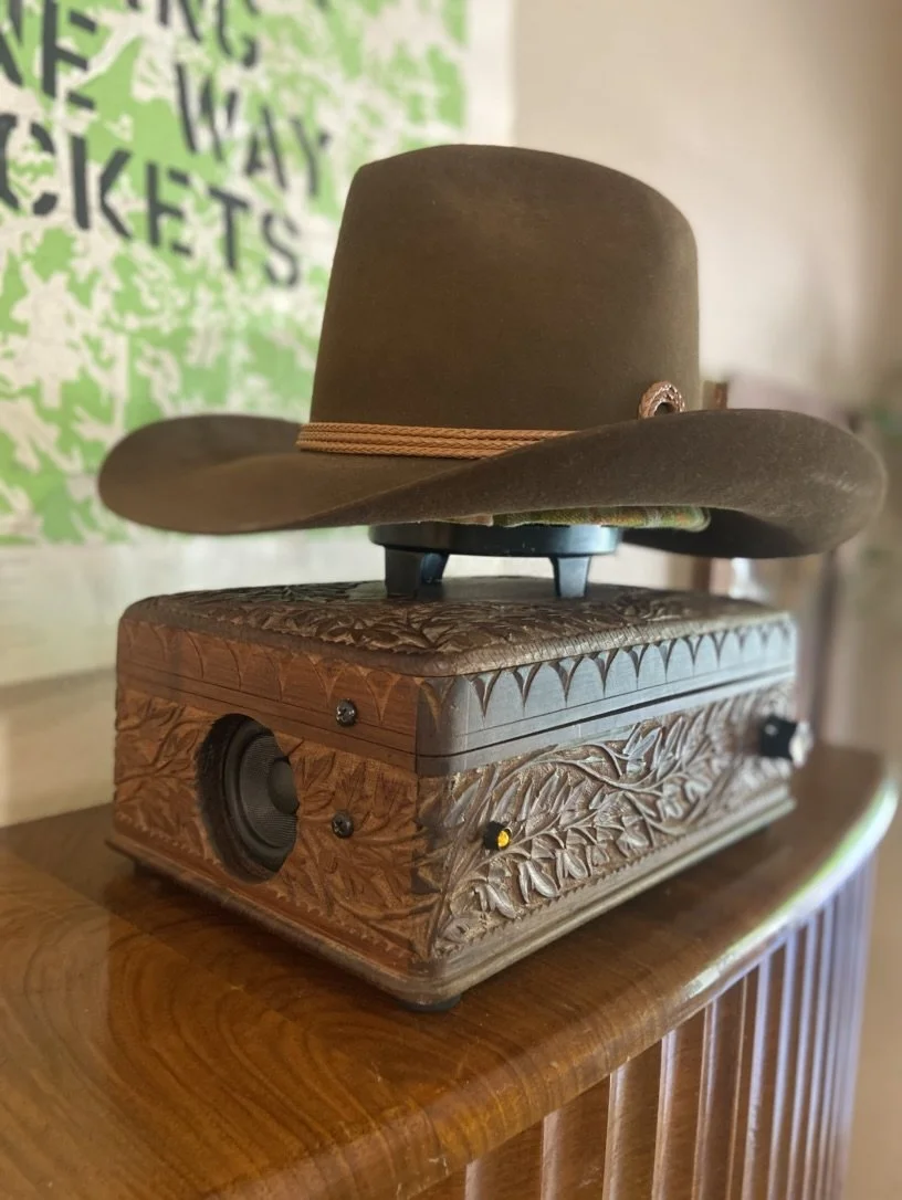 Cowboy hat on decorative wooden speaker box