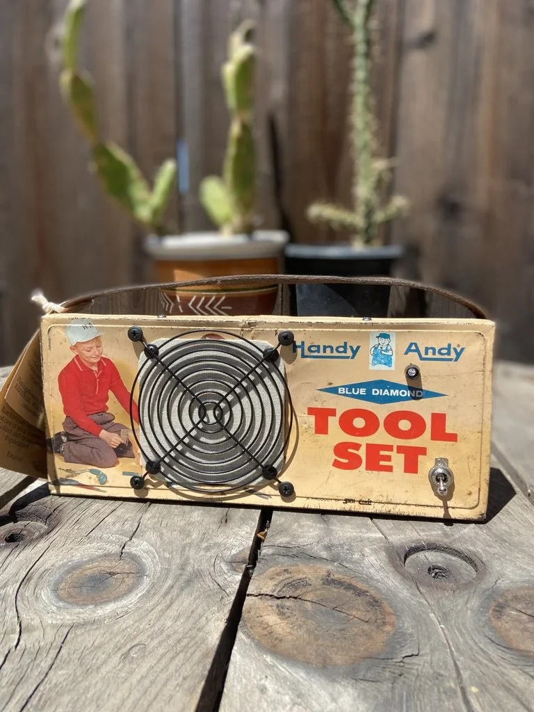 Vintage Handy Andy Blue Diamond tool set on wooden surface, with potted plants in background.