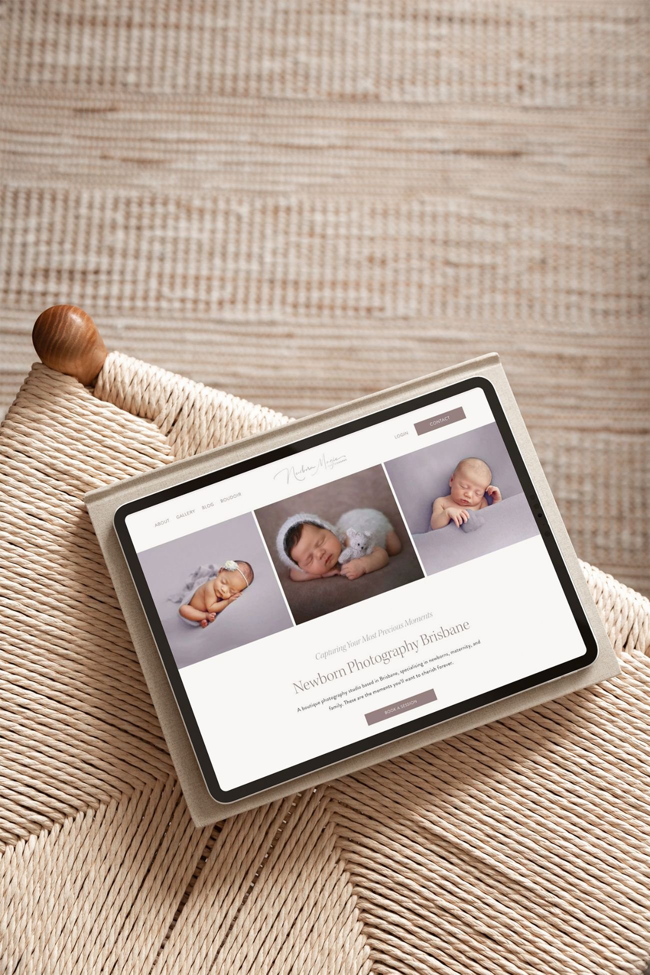 Light brown wood chair with texture, showcasing newborn photographer website design on tablet device.