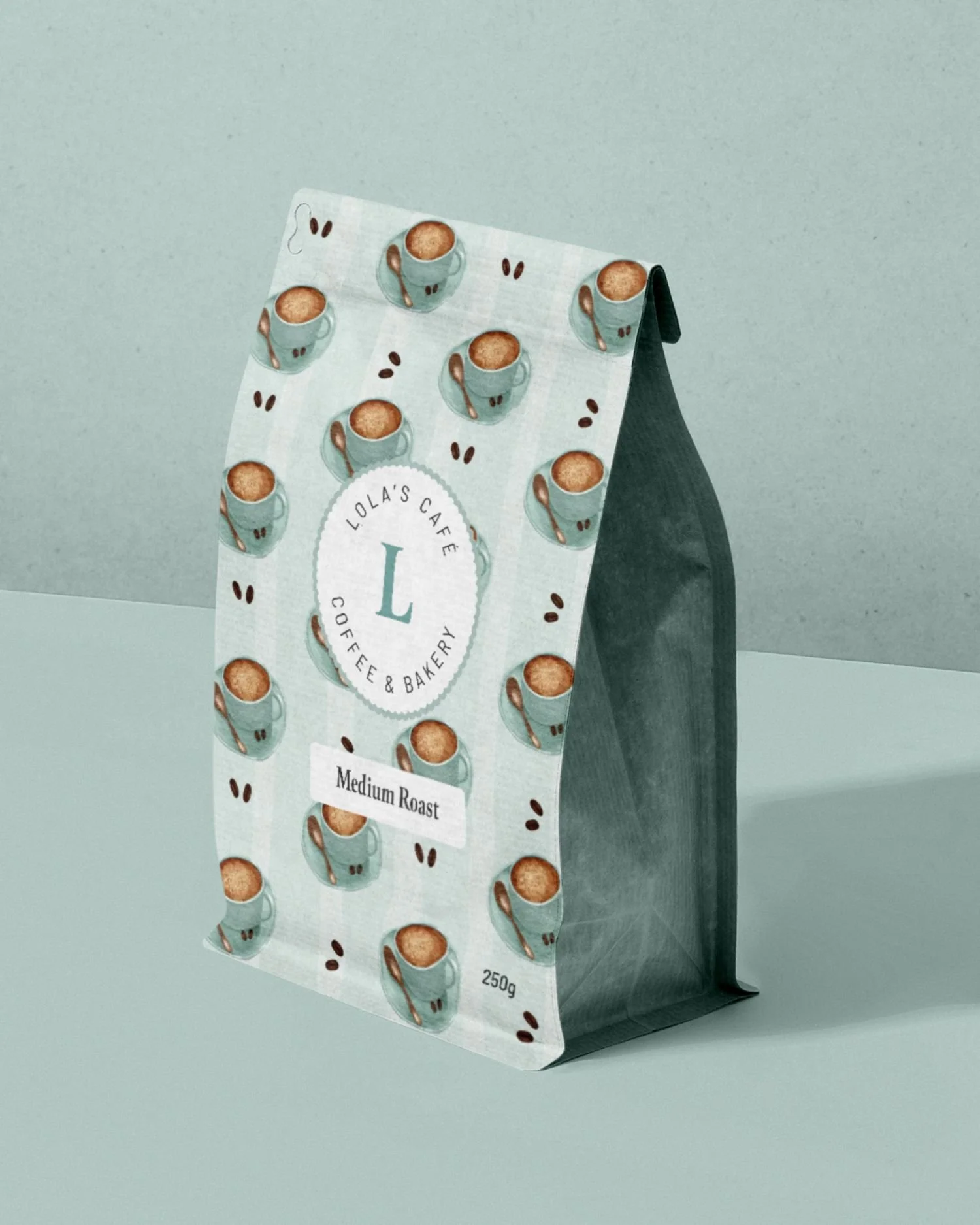 Coffee bean bag with Lola's Cafe branding. Teal blue cappuccino illustration, blue watercolour striped pattern, scalloped oval submark.