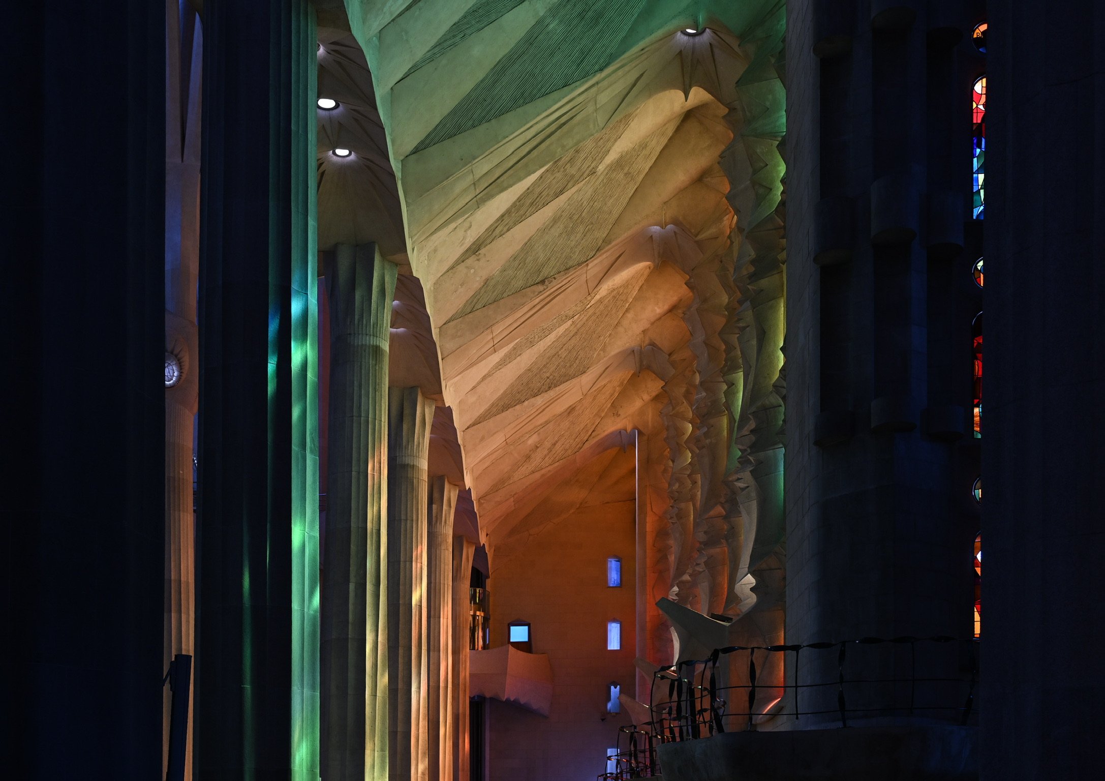 Columns illuminated by stained glass in La Sagrada Família