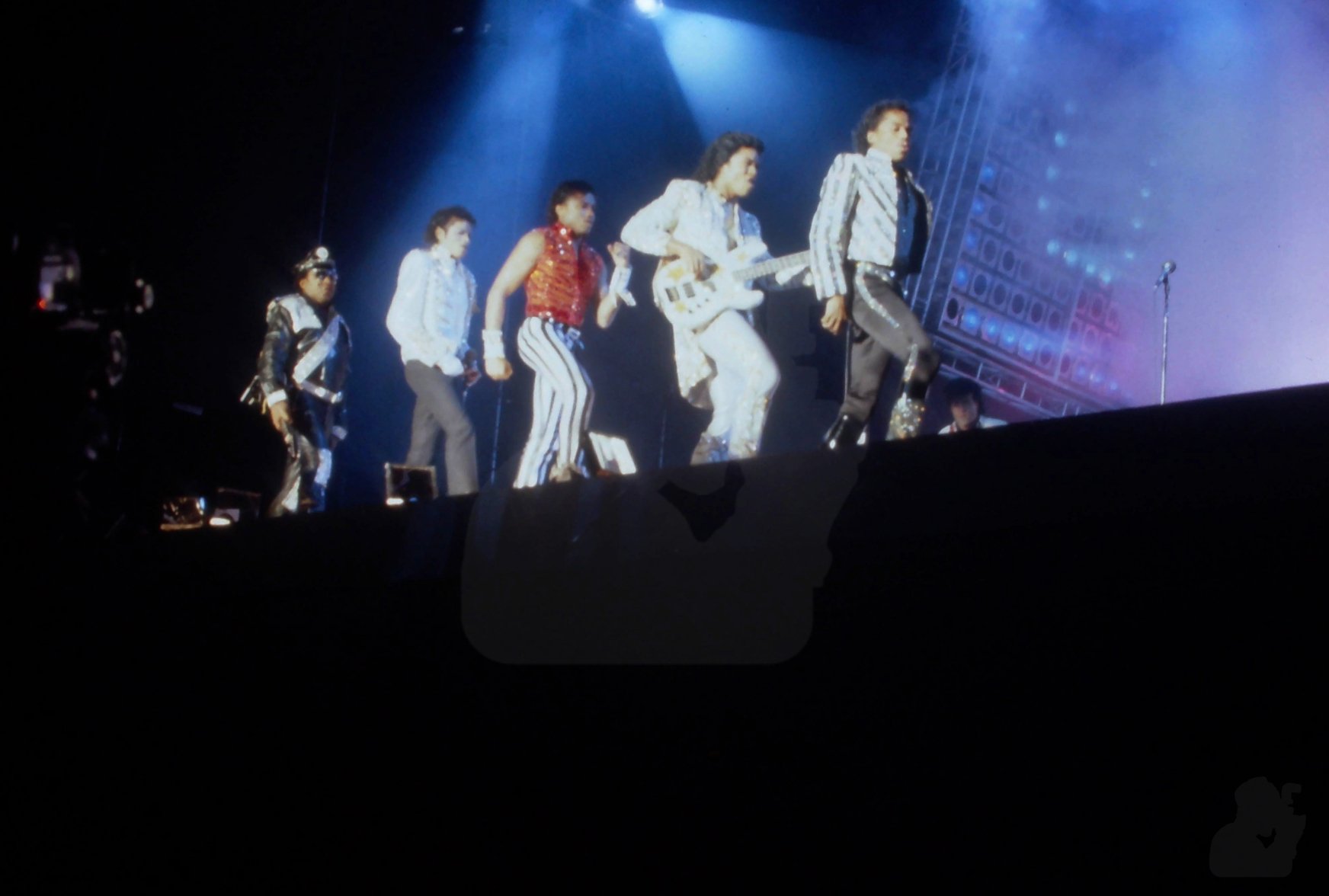 The Jacksons perform one of their signature ensemble dance routines on stage on the Victory tour, Dodger Stadium, Los Angeles, California, December 1984.