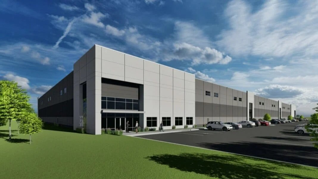 Rendering of a large modern warehouse with a parking lot and people walking near the entrance.