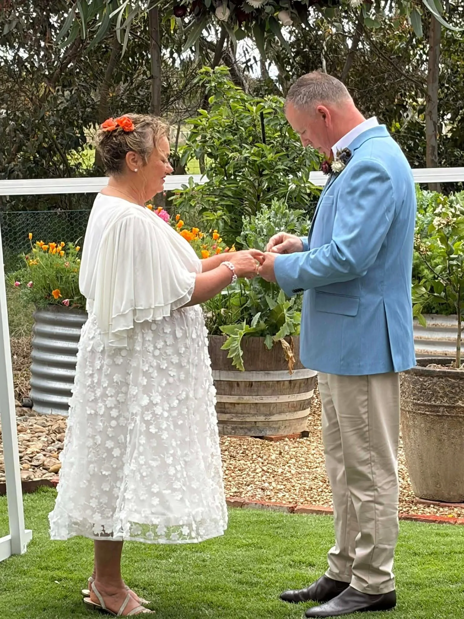 J and B exchanging wedding rings! Wedding officiated by Anthea Teakle Civil Celebrant in their backyard and beautiful garden!