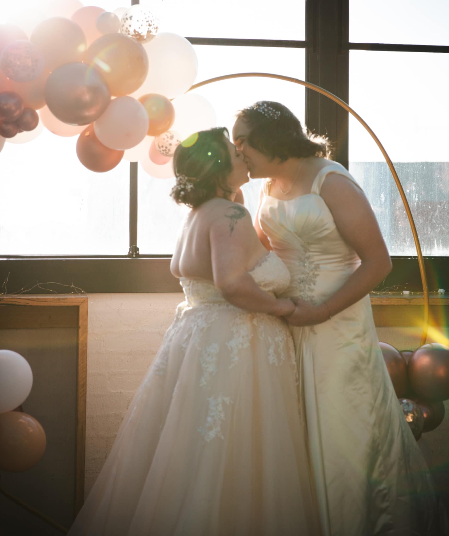 Two brides embracing after their beautiful wedding, officiated by Anthea Teakle Civil Celebrant.