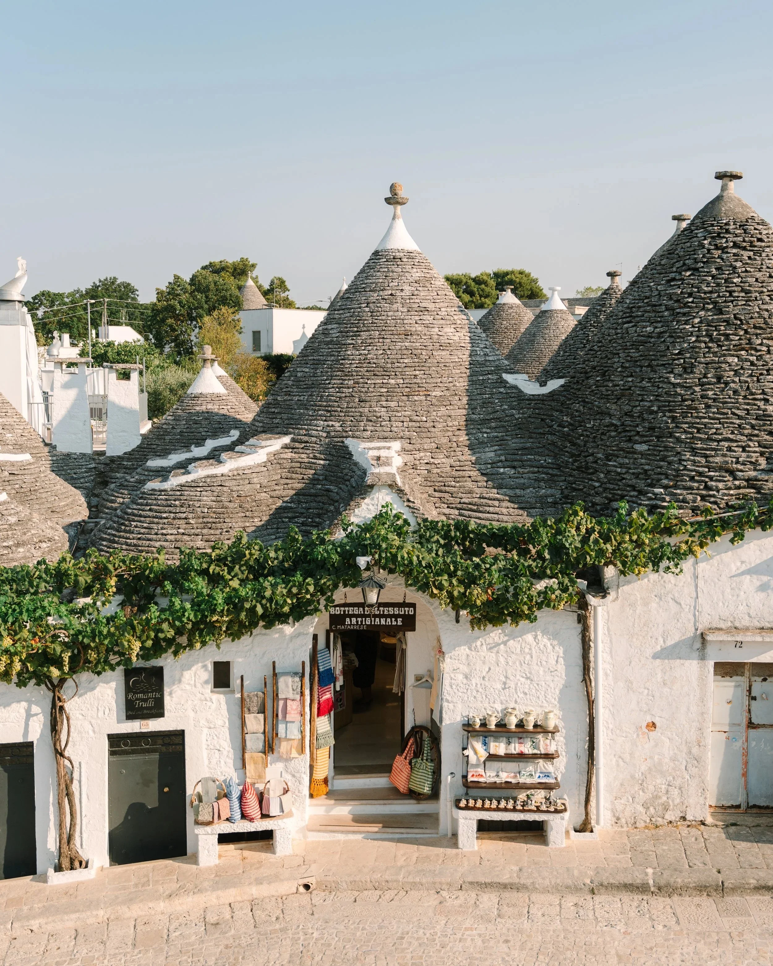 Luxury wedding reception in a historic Apulian Masseria trulli, surrounded by ancient olive trees. High-end destination wedding photography in Puglia by Giacomo Lai.