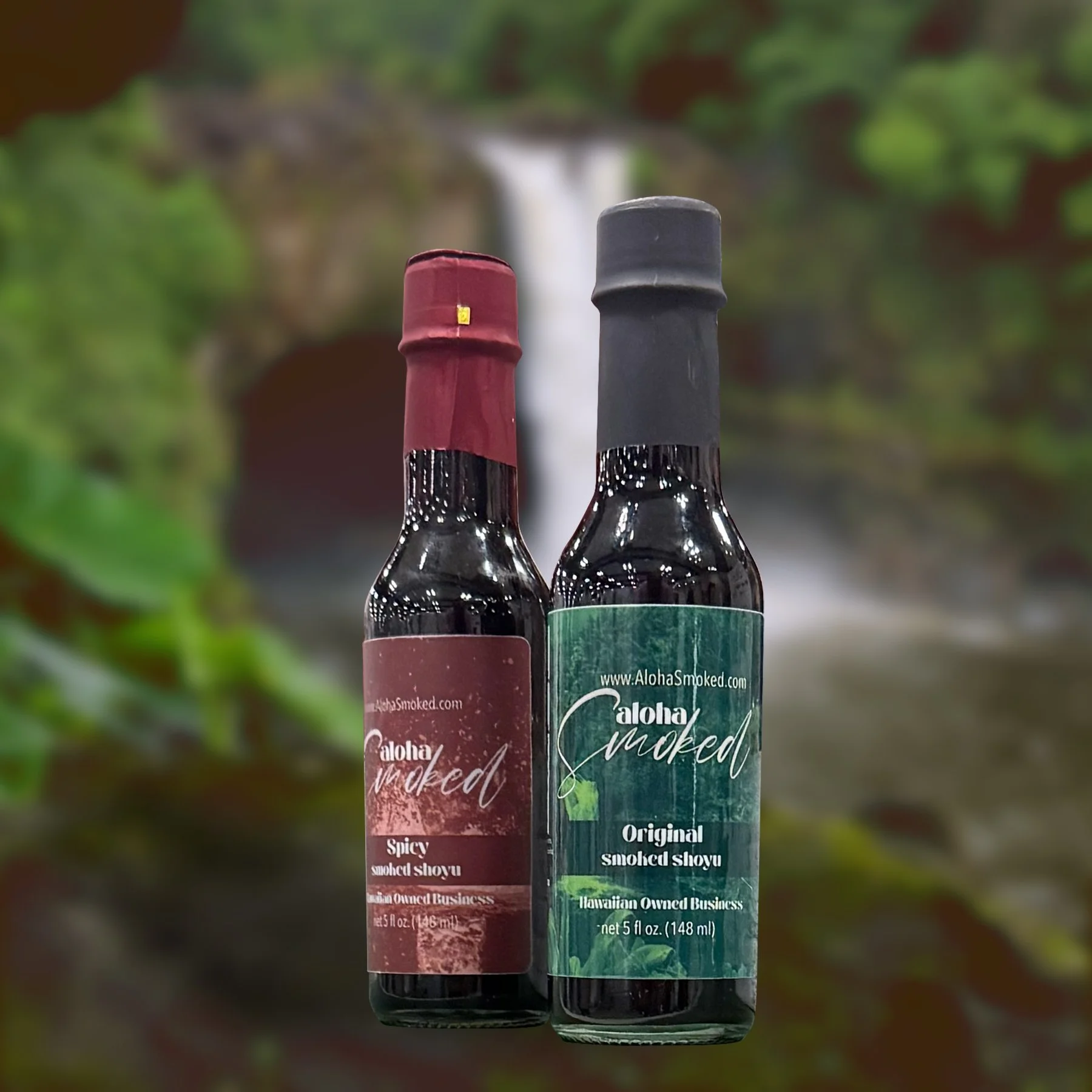 Two bottles of smoked shoyu, one spicy and one original, with a waterfall in the background.